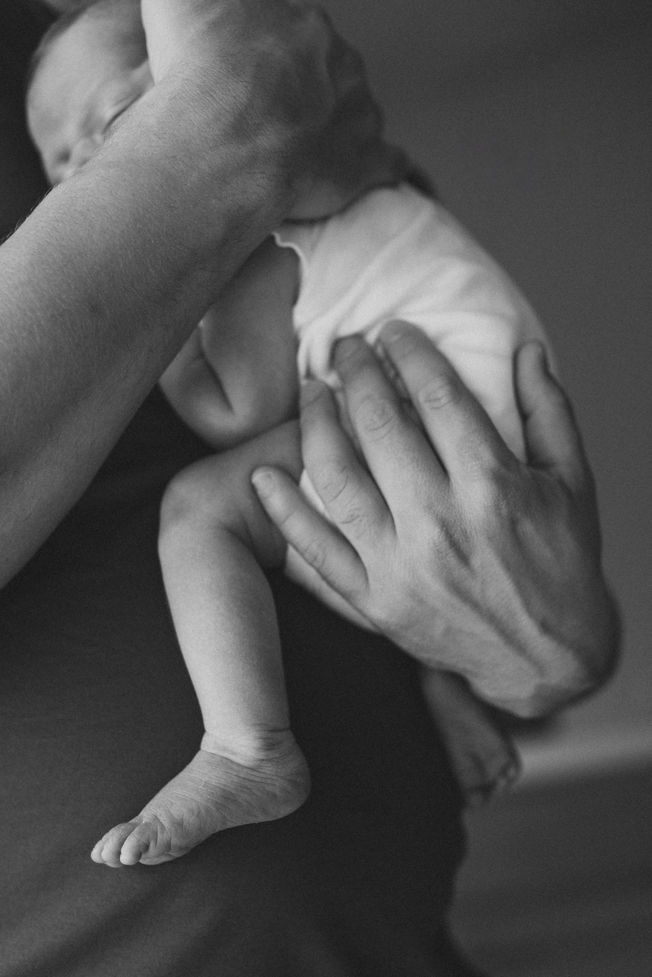 dad is holding a newborn baby