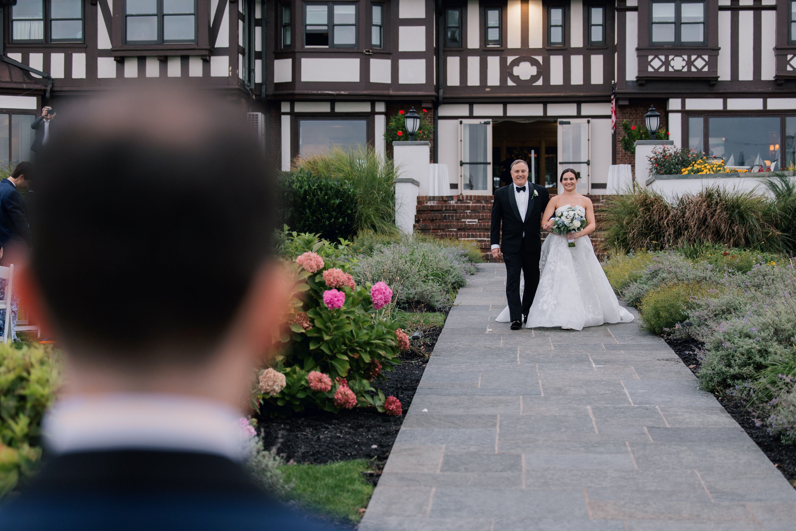 a bride and groom walking down the aisle
