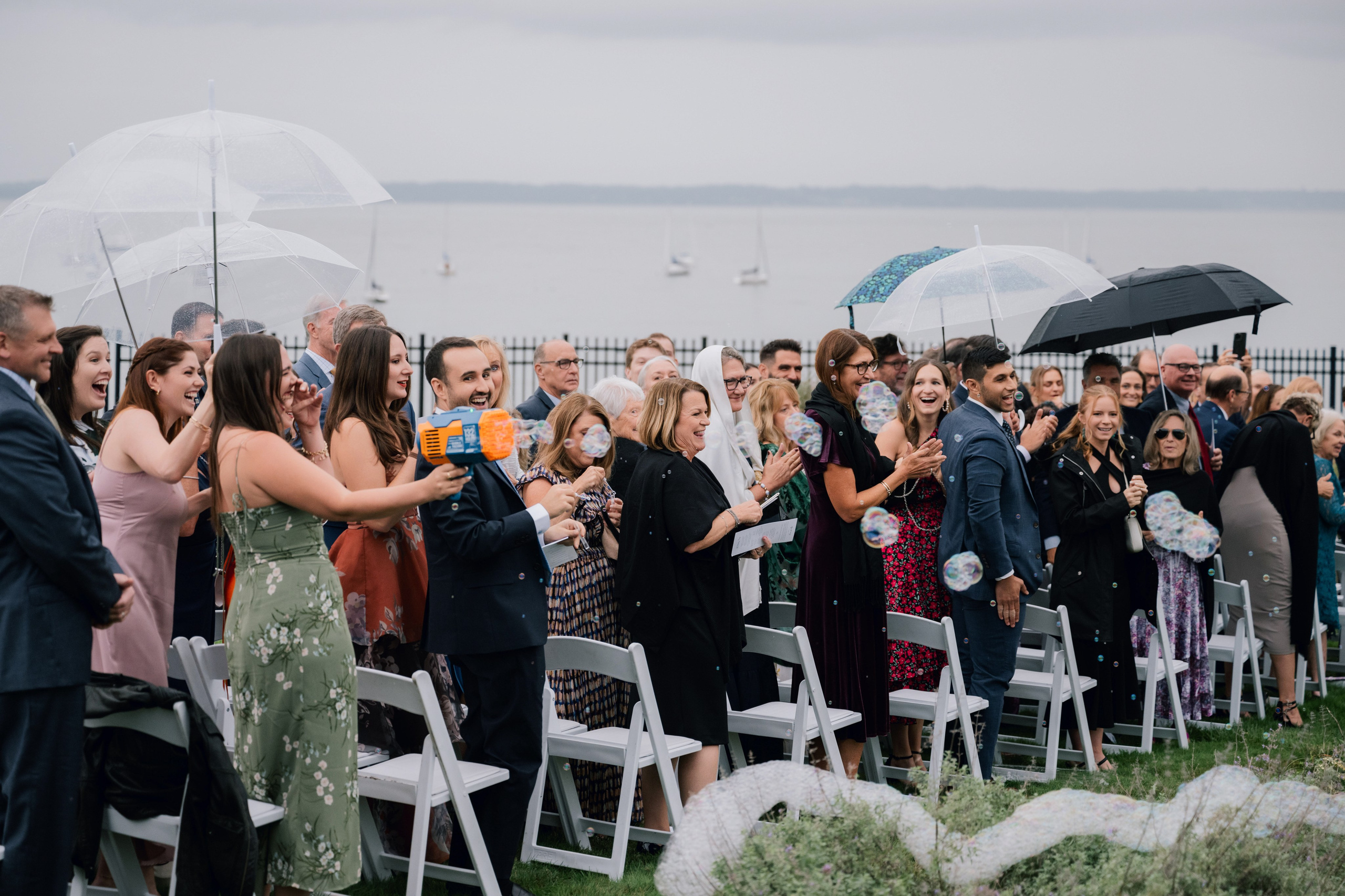 a group of people standing under umbrellas