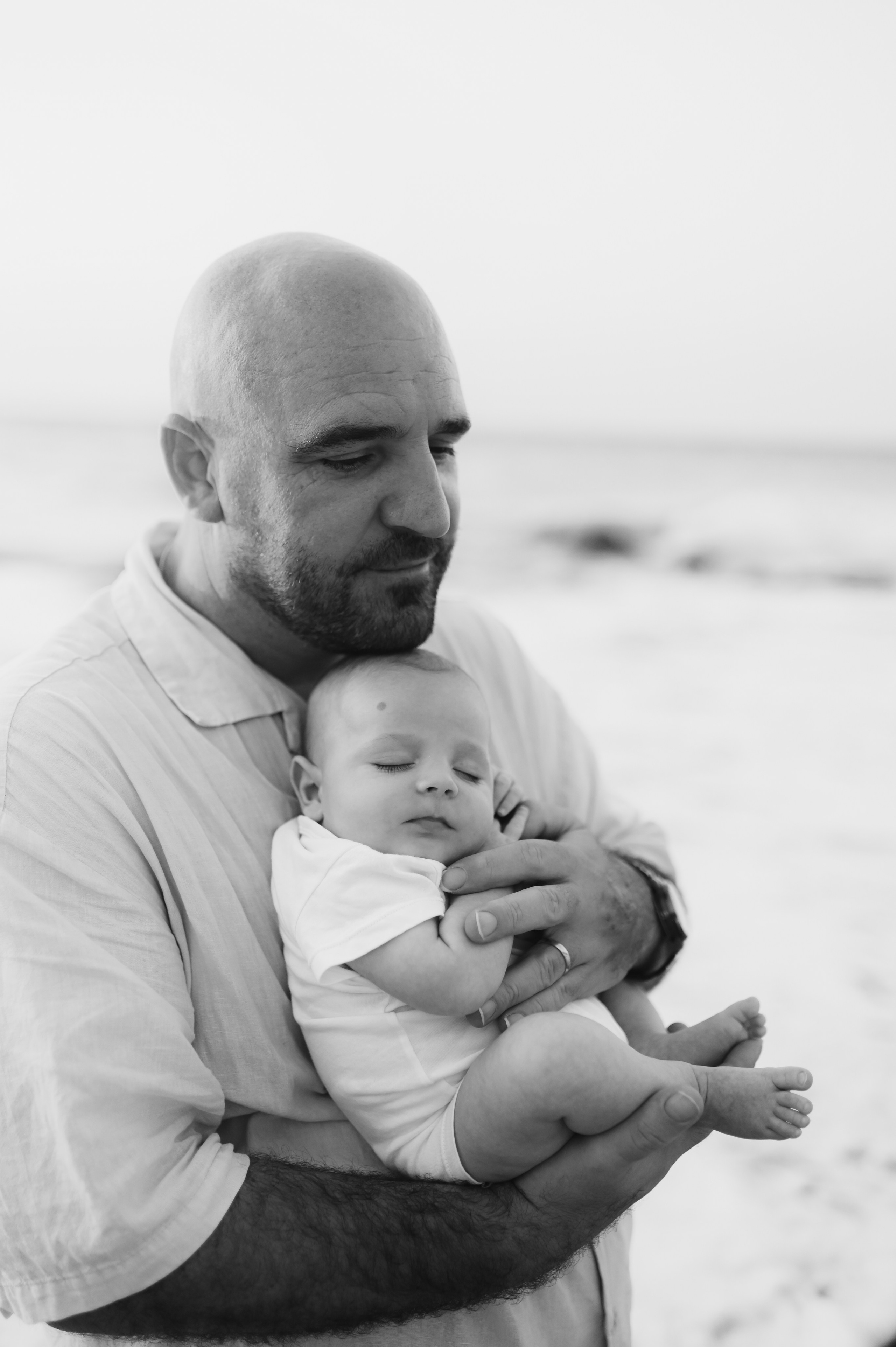 Happy family walking along a Rhodes beach at sunset. Photographer in Rhodes Island