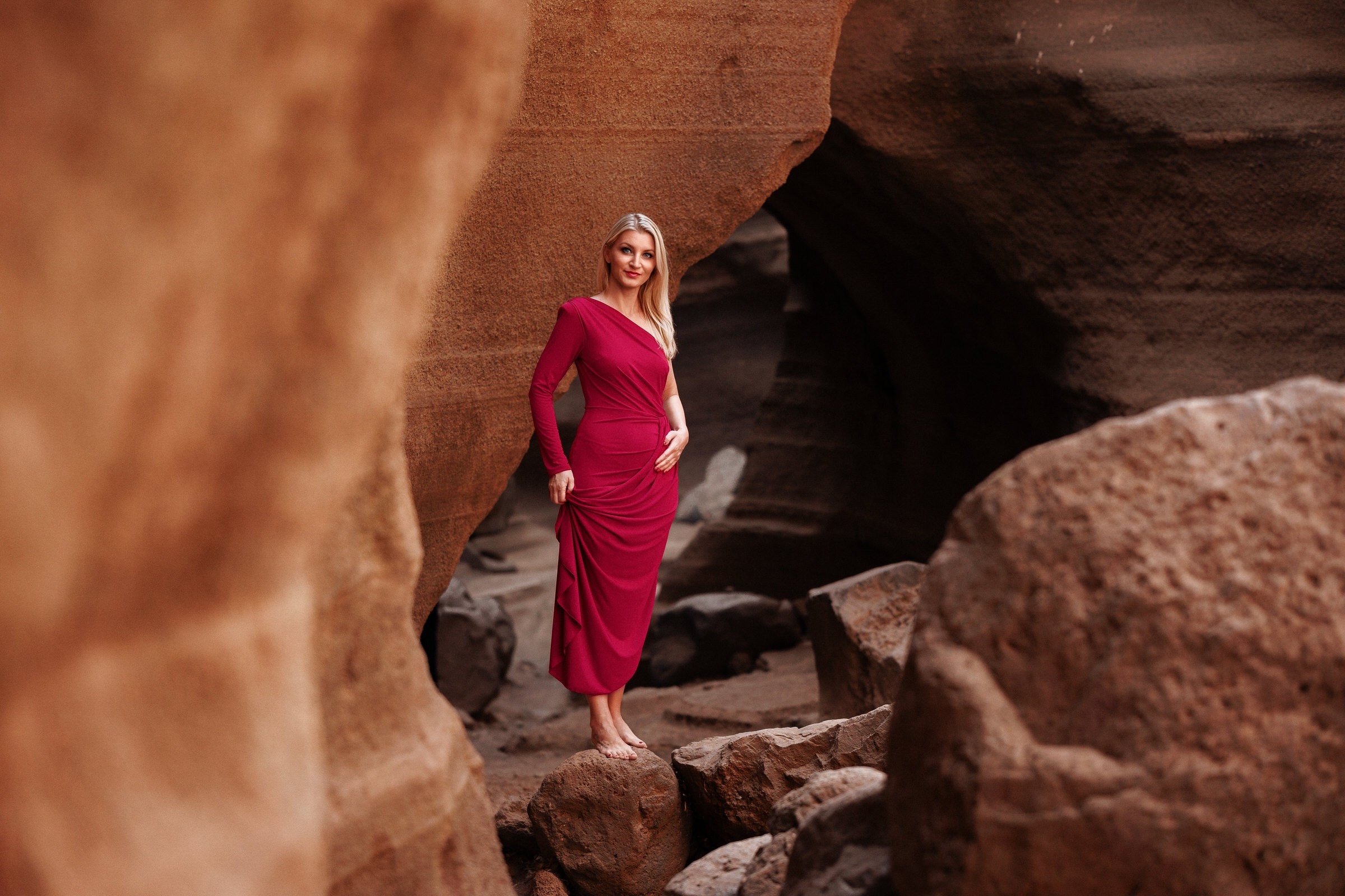Barranco de Las Vacas Photo Shoot A woman in a red dress standing in a rock formation.