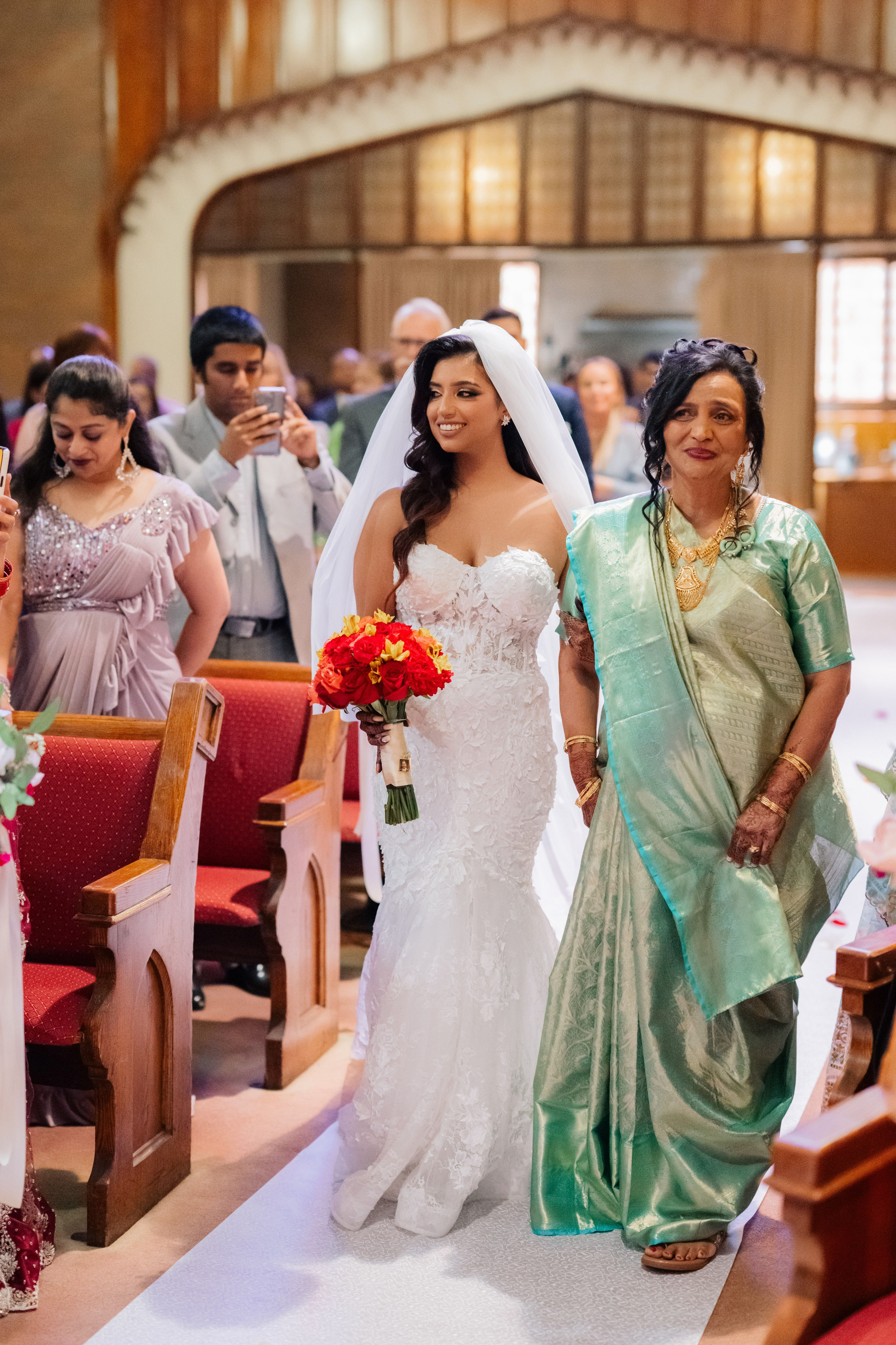 a bride and her mother walking down the aisle