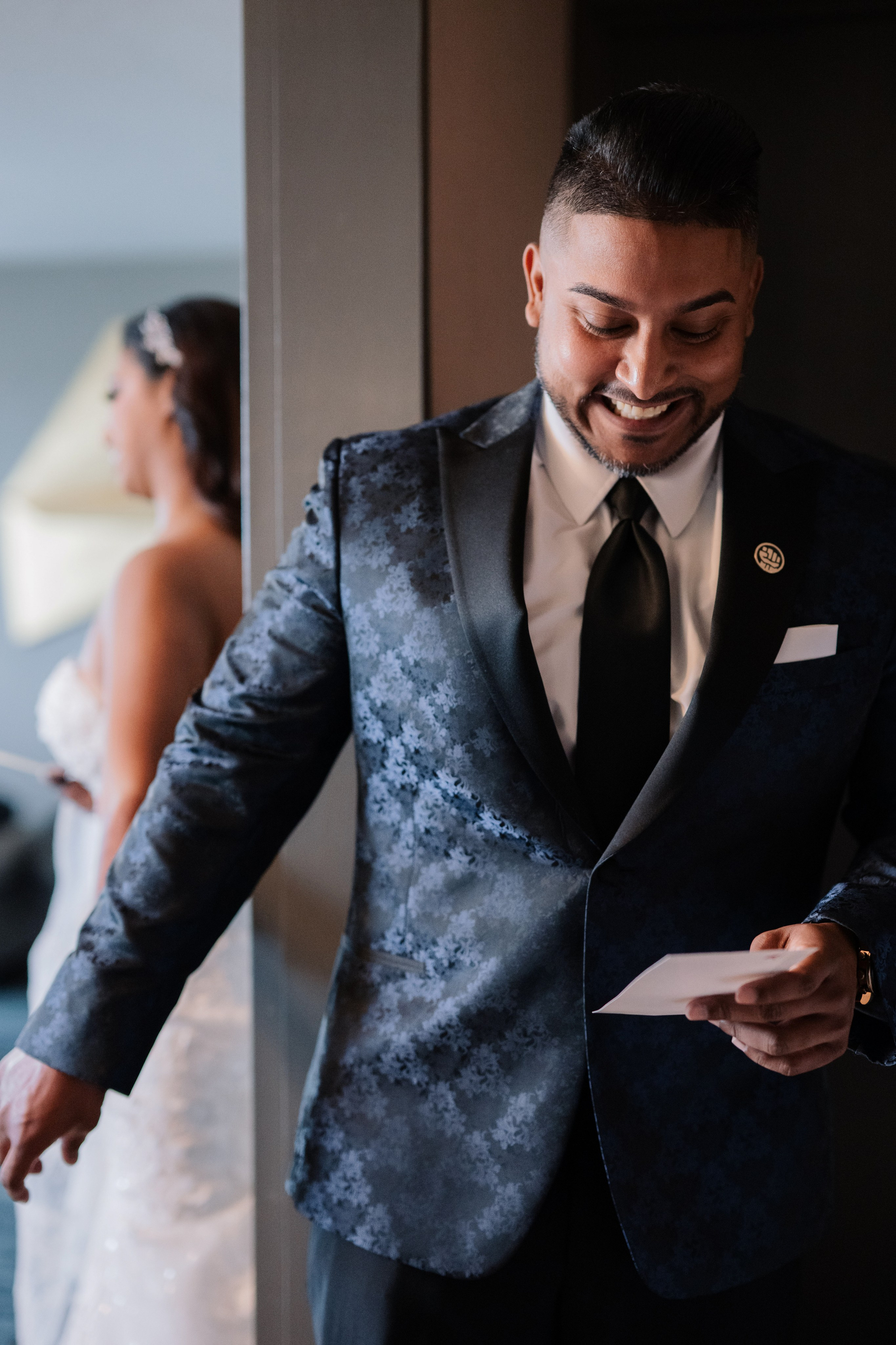 a man in a suit and tie is looking at his phone