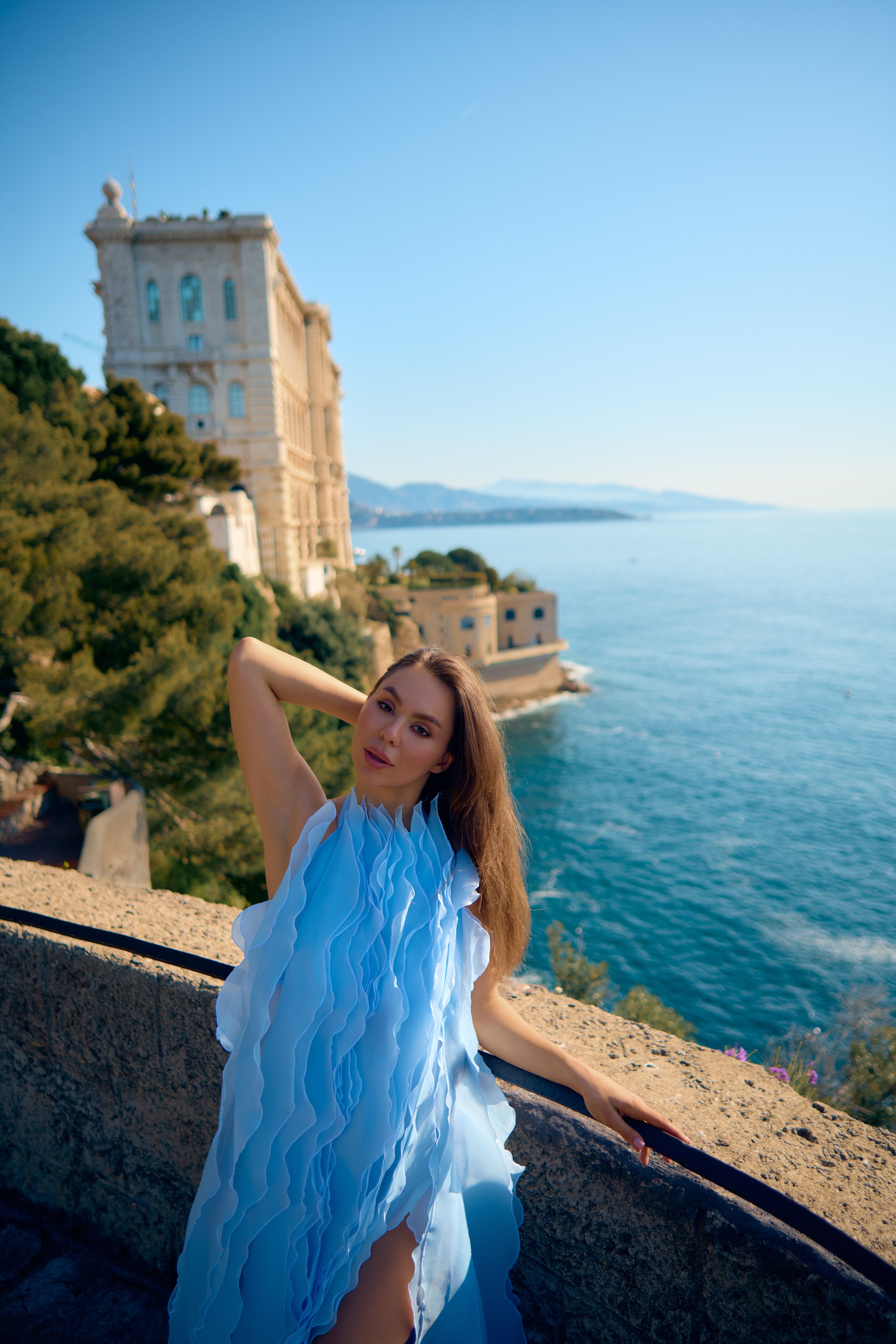 Artistic shot of model in blue evening gown with luxury background Monaco