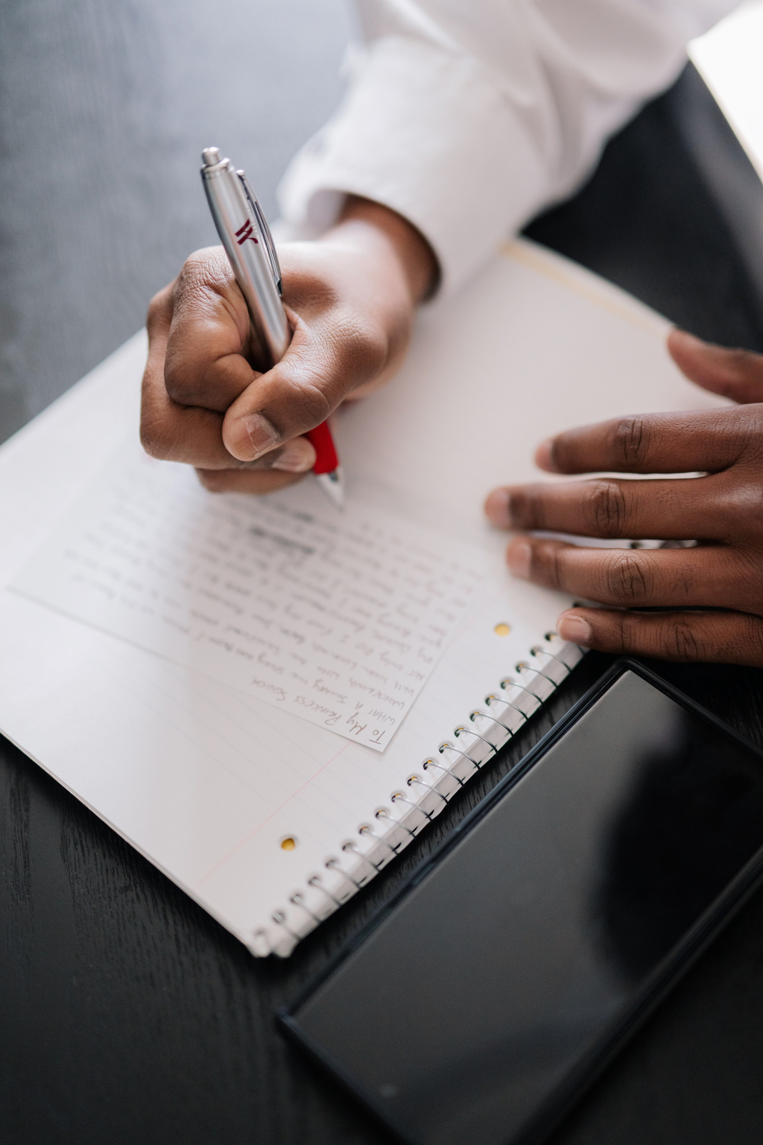 a person writing on a note pad