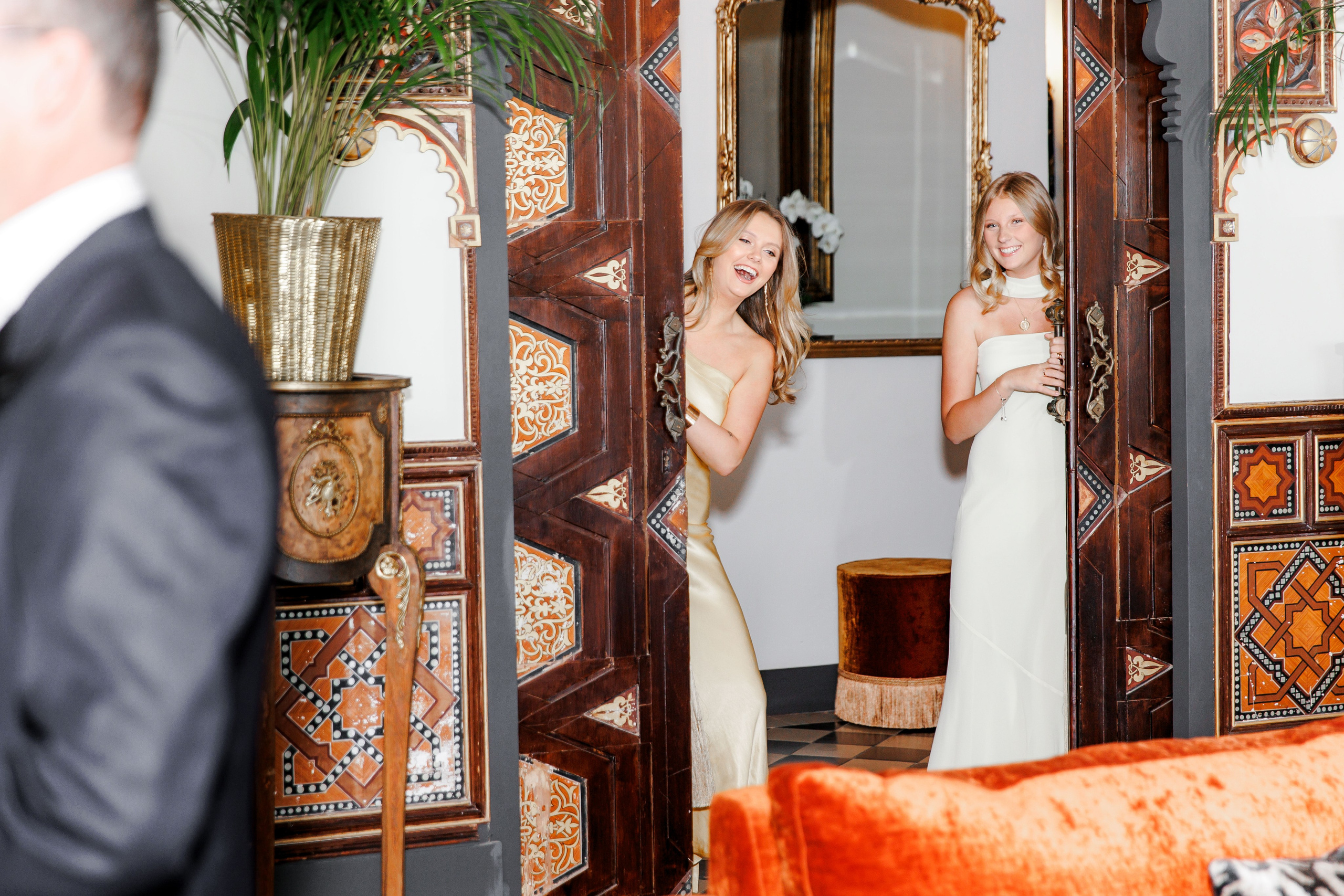 Candid moment of the groom laughing with family before the ceremony