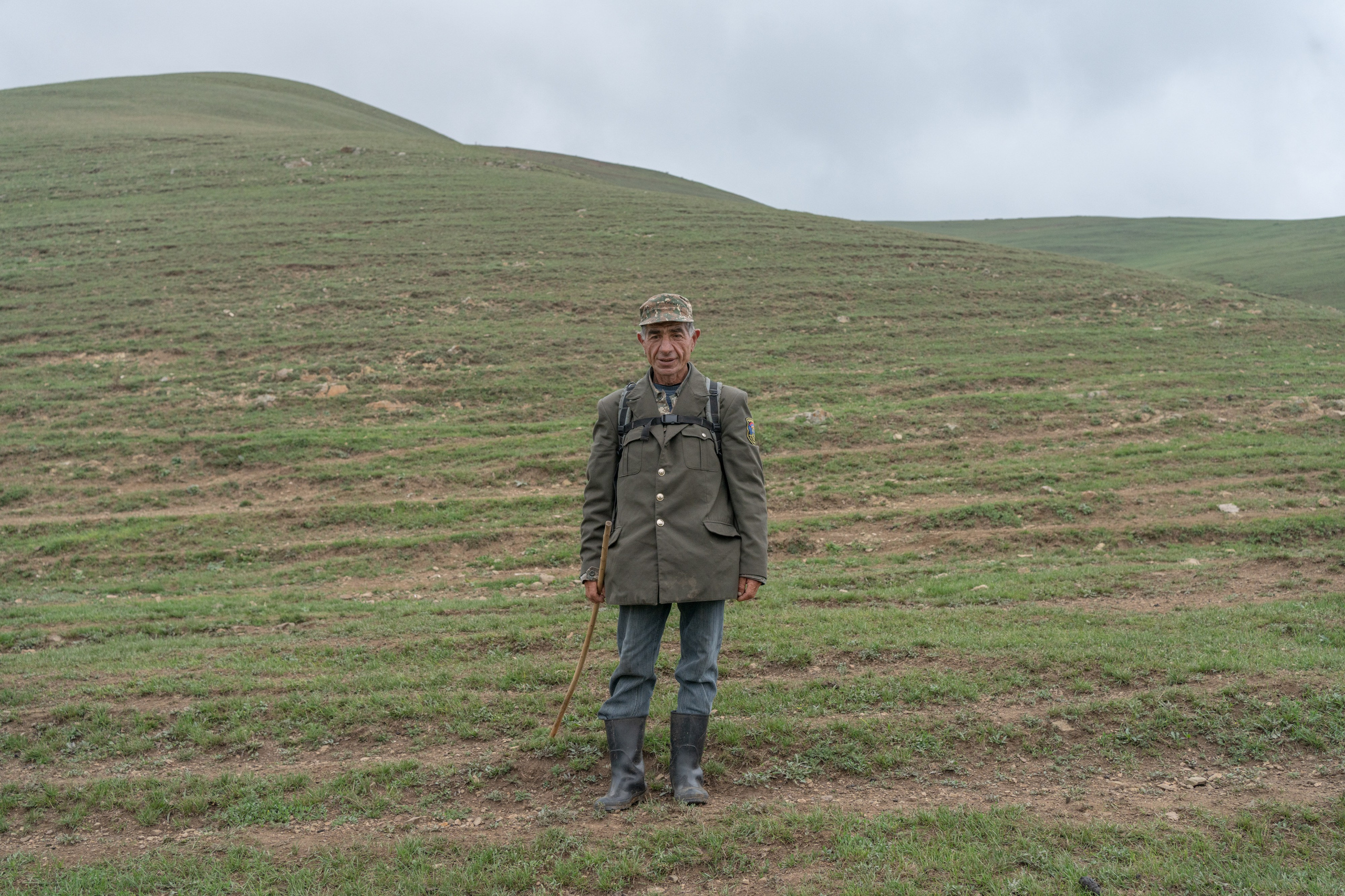 Kamo Gevorkian has been working as a shepherd for nearly 40 years in a bordering village of Chmabarak, Armenia. He leaves his house before dawn and returns right before the sunset. Despite his second-degree disability, he goes to the mountains every day during the season. In the 1990s, Kamo accidentally crossed the Armenia-Azerbaijani border because of foggy conditions in the mountains. He was taken prisoner. Kamo said that before the First Nagorno-Karabakh war, he used to graze his cows and sheep alongside Azerbaijani shepherds. They often ate lunch not far away from each other. When Kamo was captured, one of the Azerbaijani shepherds recognized him. He spent a week tied up, after which he was released.