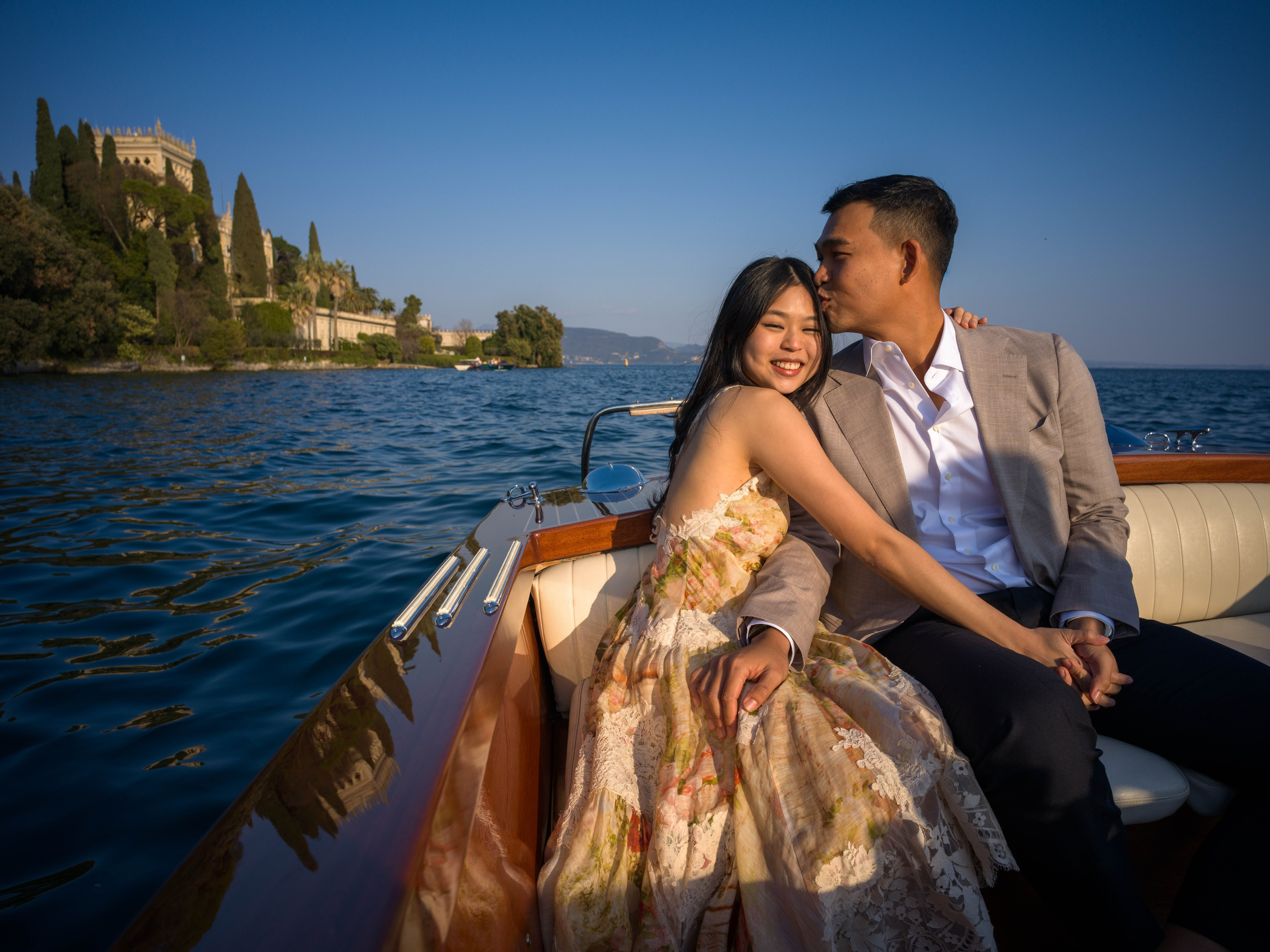 Couple celebrating engagement on Lake Garda near Isola del Garda.