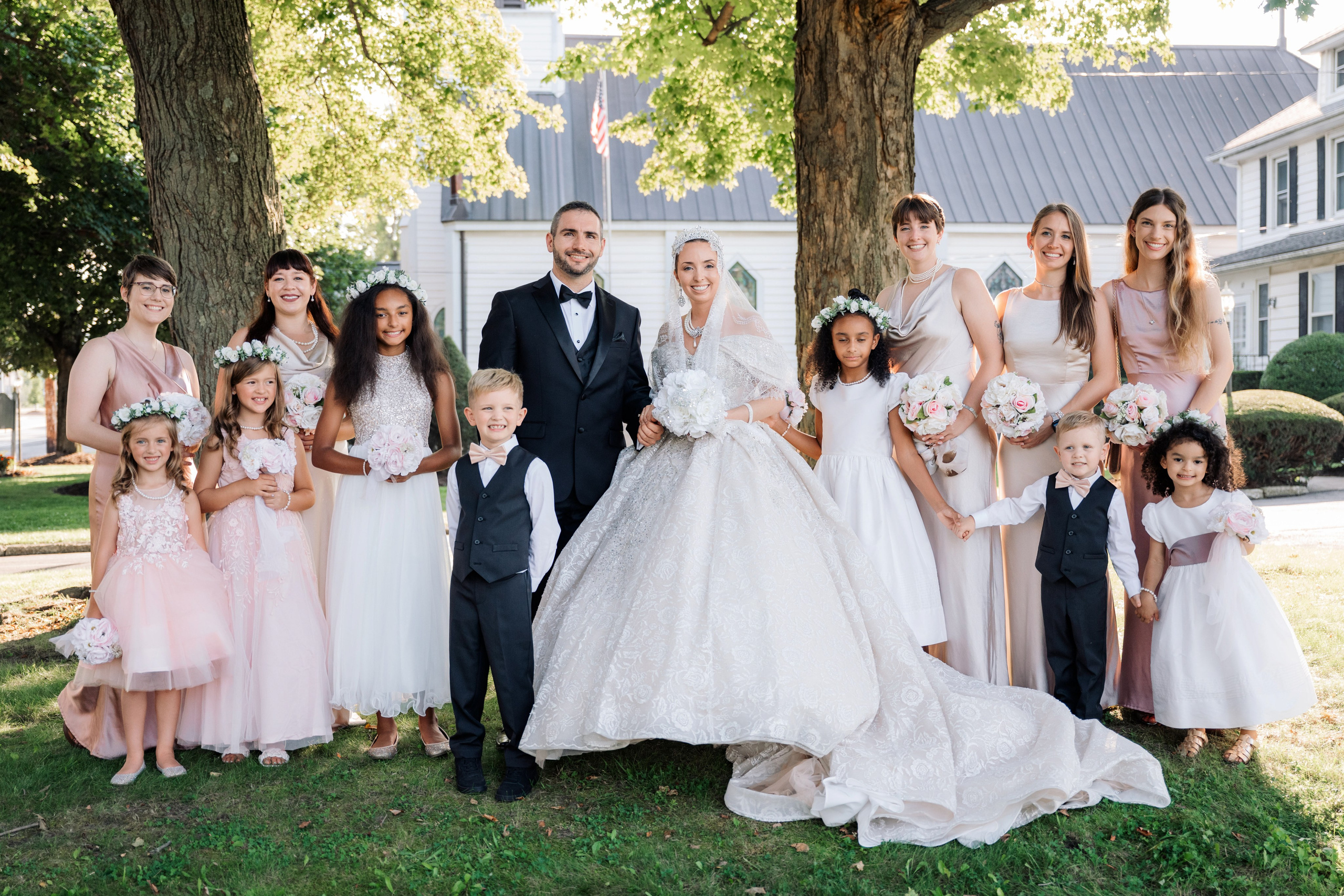 a bride and groom pose with their wedding party