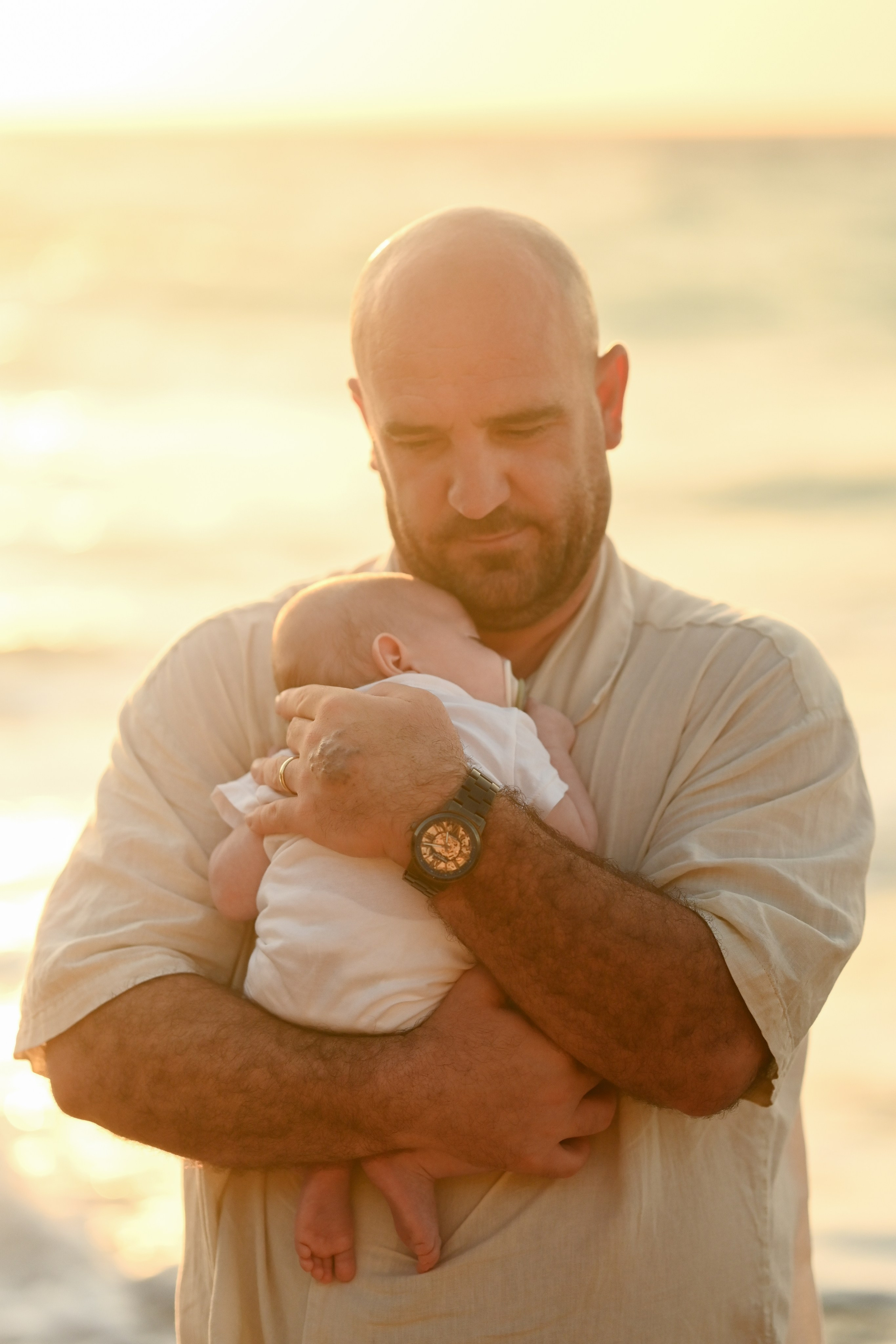 Happy family walking along a Rhodes beach at sunset. Photographer in Rhodes Island