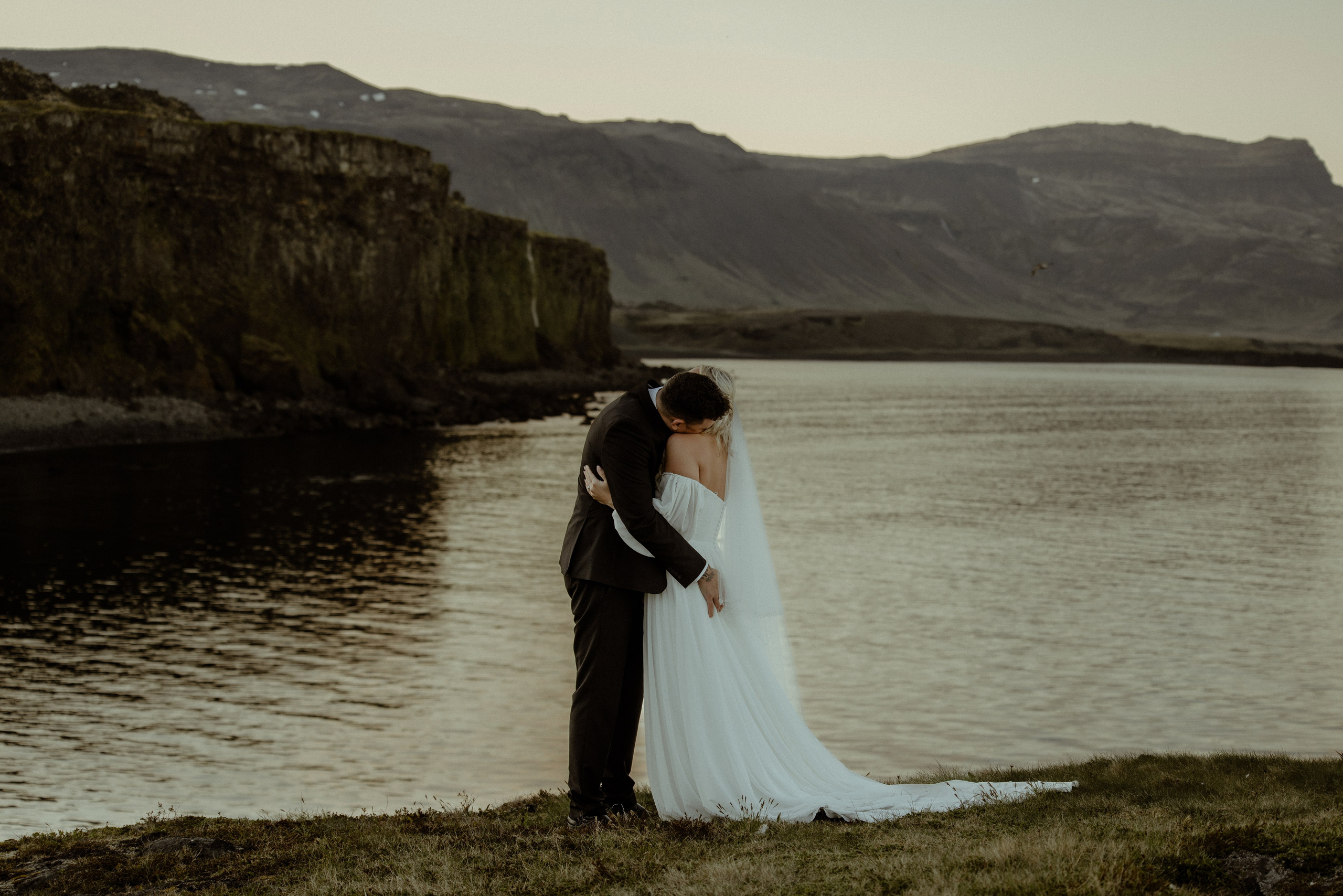 Iceland elopement at Budir with midnight sun wedding photos at black sand beach. Iceland elopement photographer & videographer