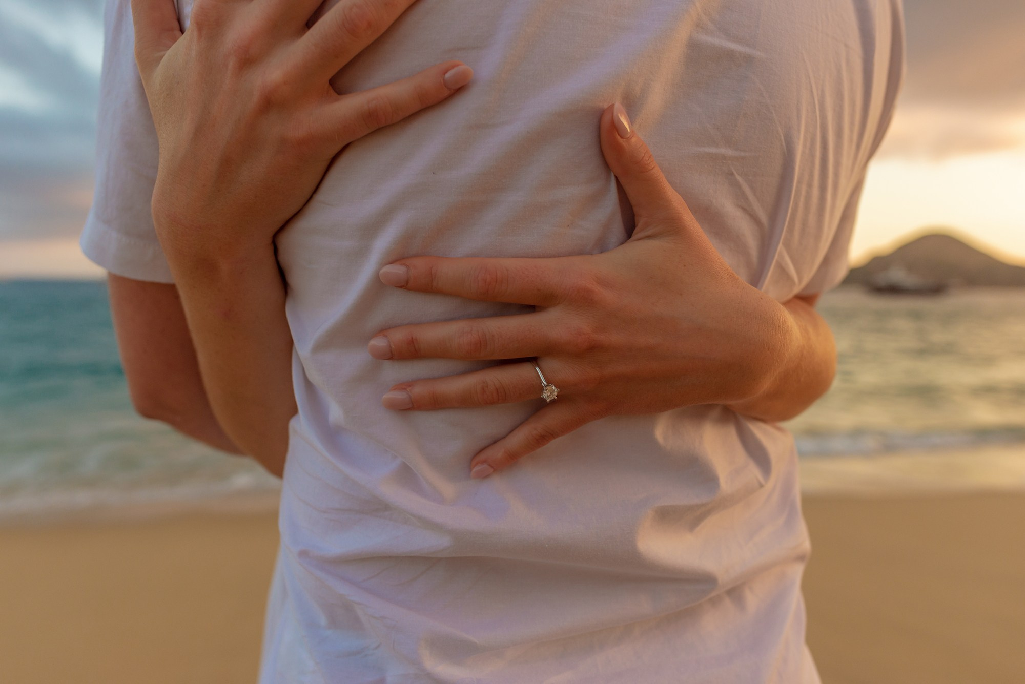 Newly engaged couple hands with engagement ring Los Cabos Mexico