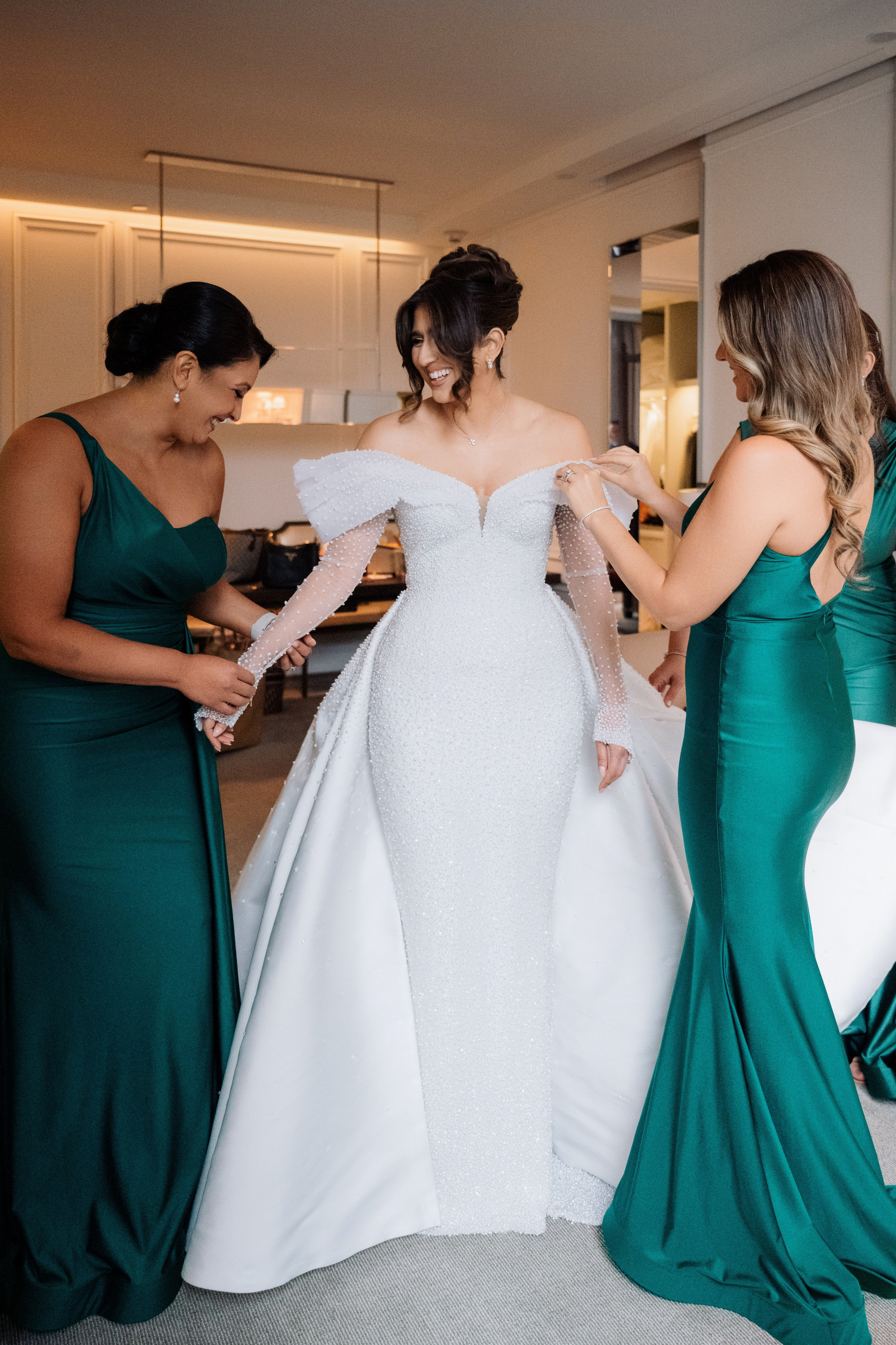a bride and her bridesmaids getting ready for their wedding