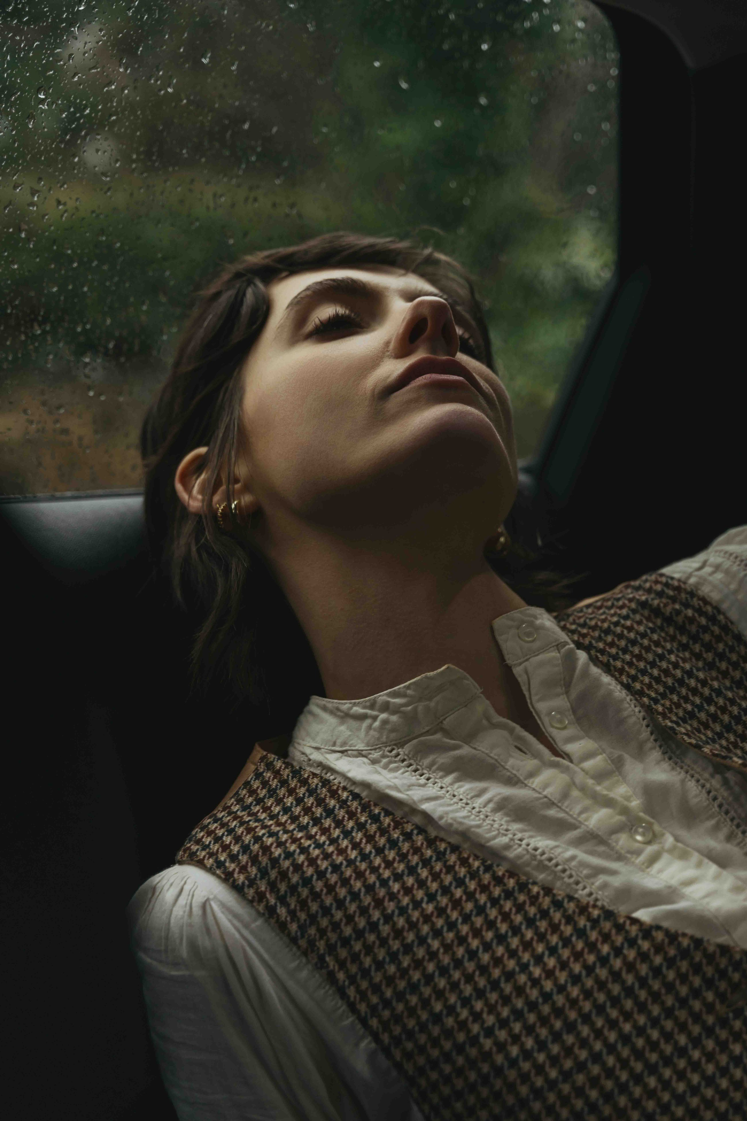 cinematic portrait of woman in Cotswolds engagement session with soft natural light and moody tones