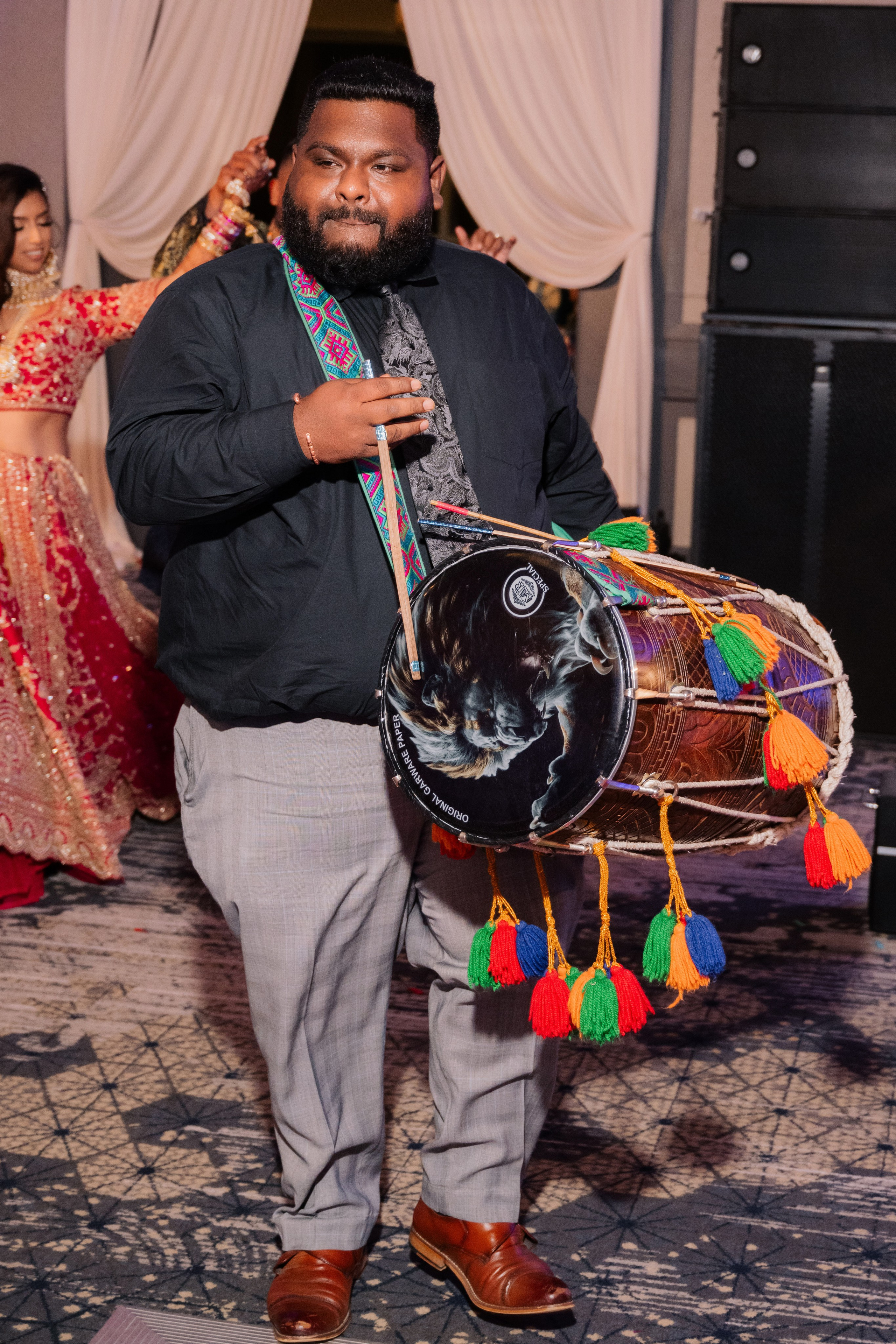 a man in a suit holding a drum