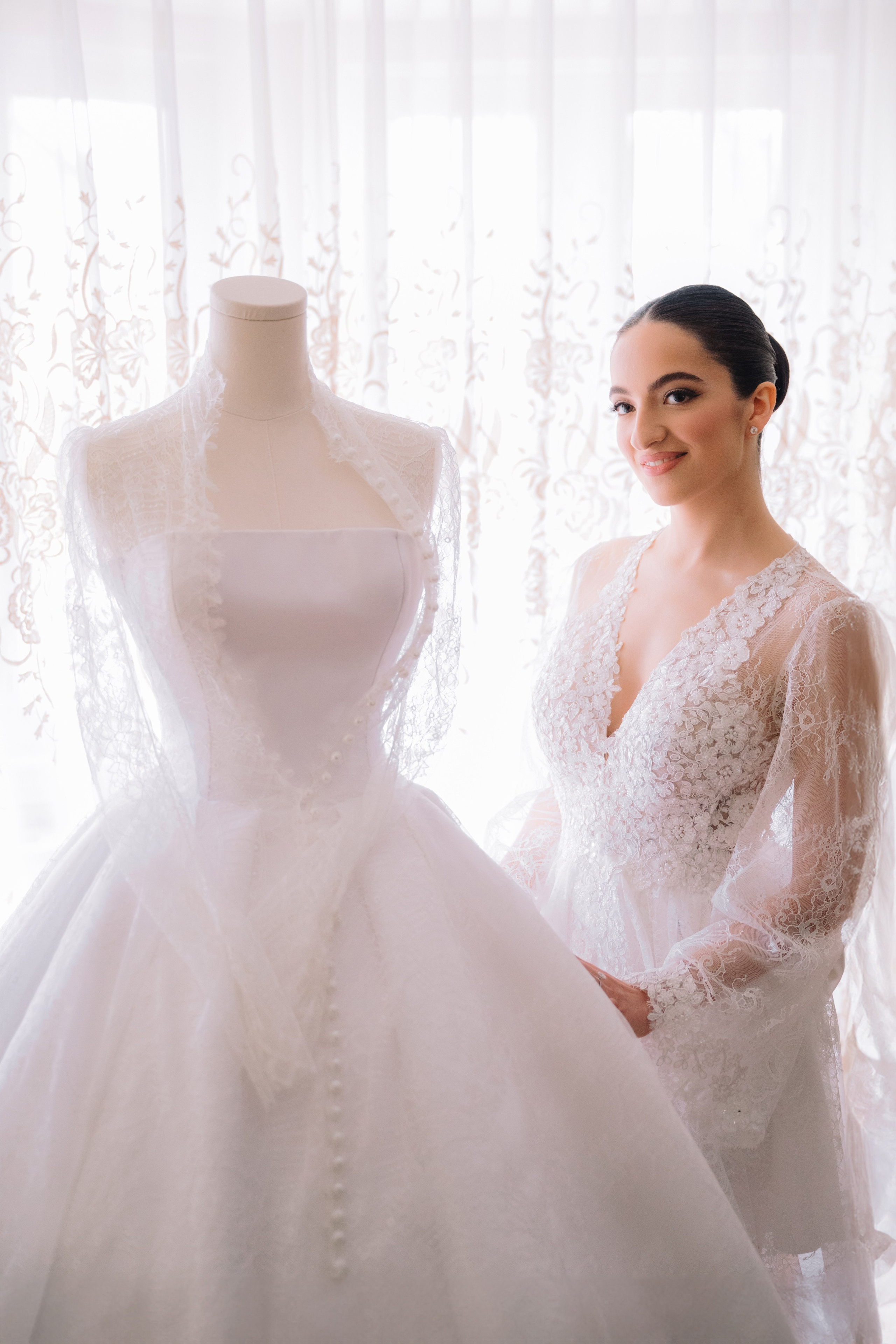 a woman in a wedding dress standing next to a dress