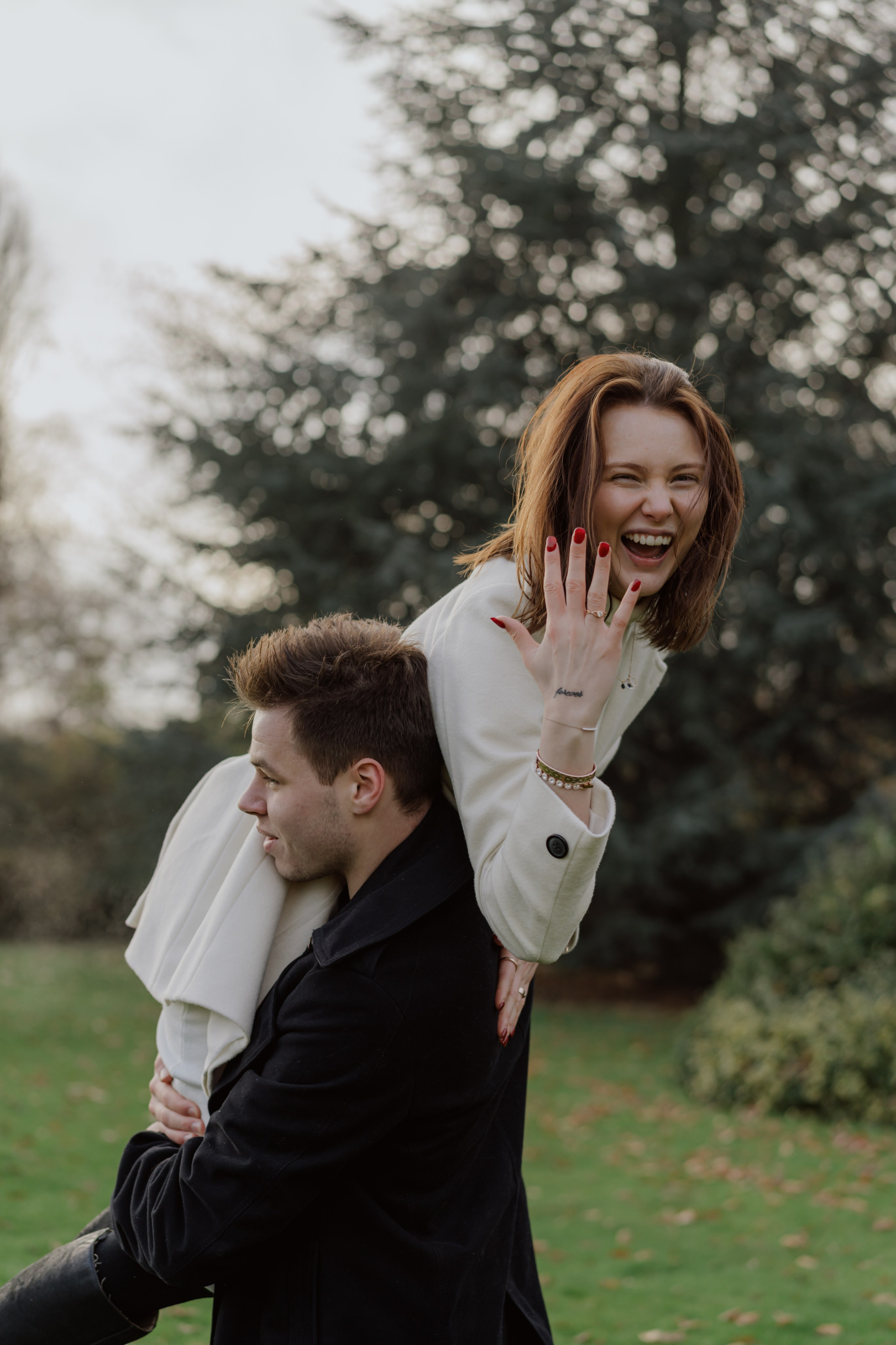 Couple laughing during a natural London photoshoot in the park