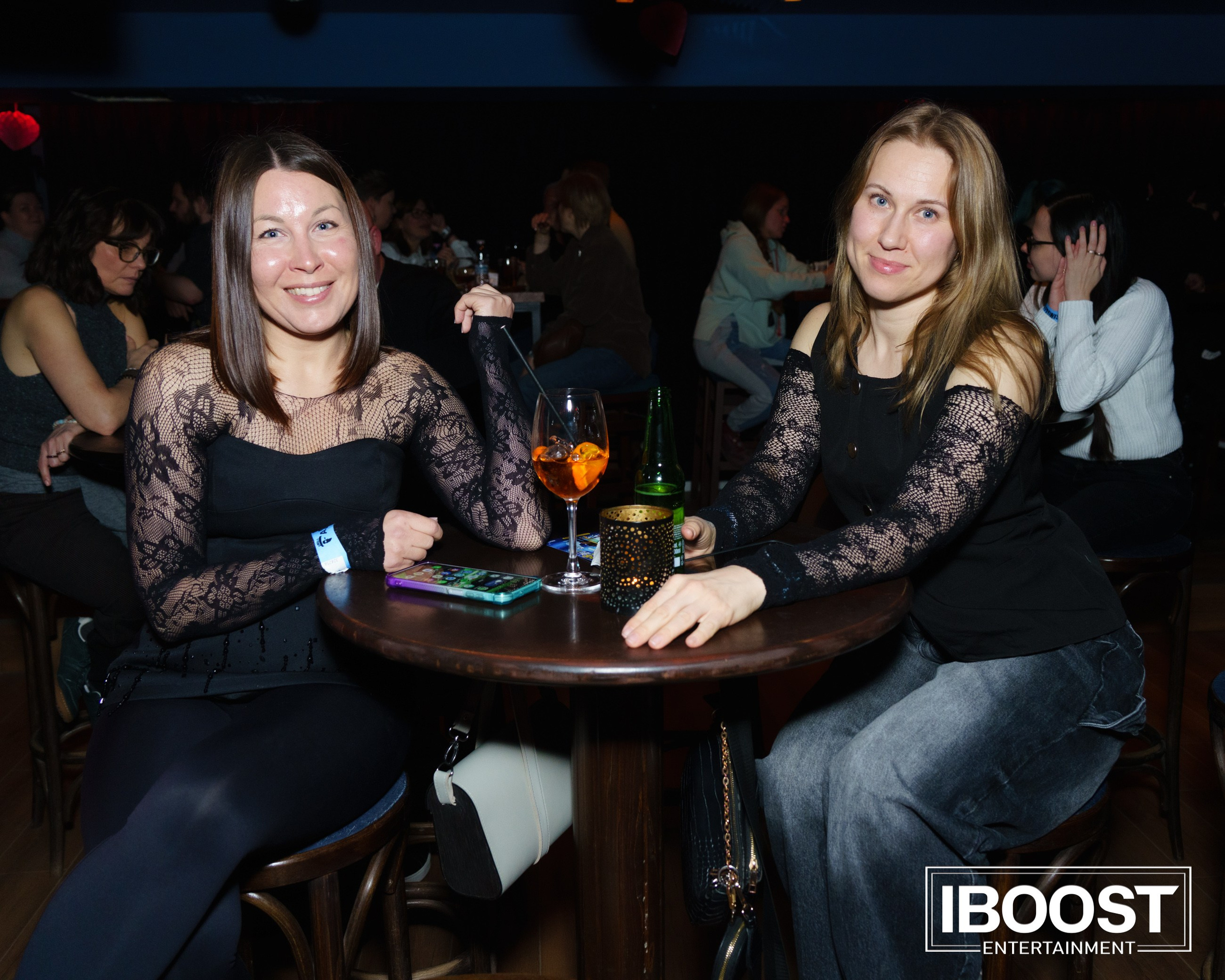 Two women sitting at a small table with drinks during the Animal JazZ concert in Sofia.