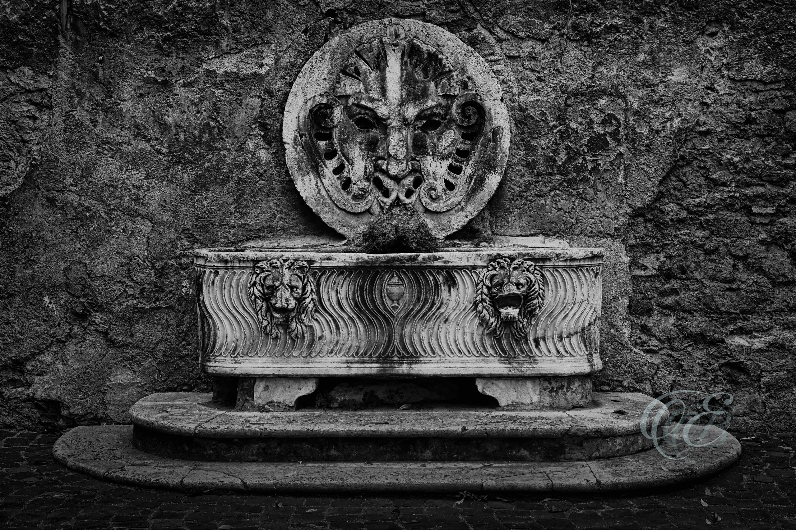 Rome Italy – Mattei Palace of Jupiter Ancient Roman mask mysterious – B&W – Eduardo Bartoli Fine Art Photography – Mysterious black-and-white photograph of the ancient Roman mask at the Mattei Palace of Jupiter in Rome, Italy, by Eduardo Bartoli.