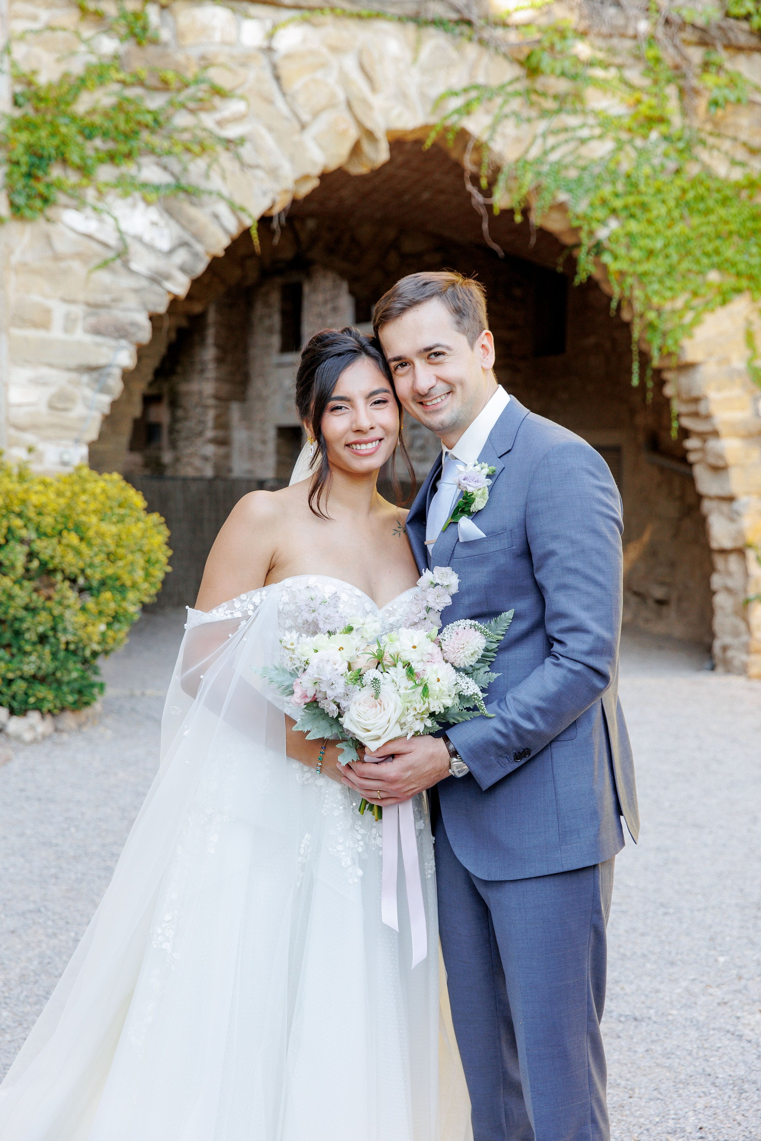 Elegant bride and groom portrait taken in a picturesque garden of La Baronia venue.