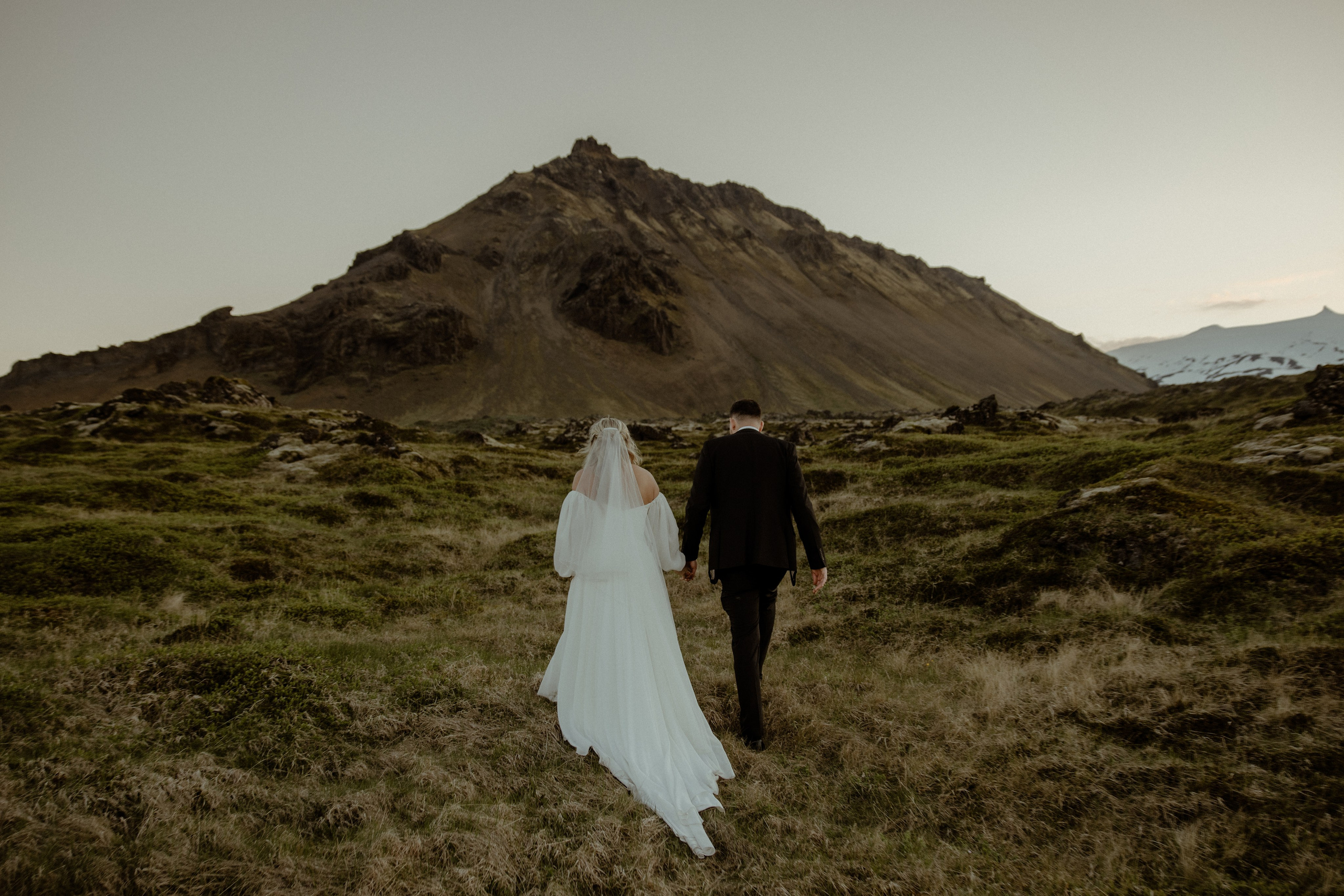 Iceland elopement at Budir with midnight sun wedding photos at black sand beach. Iceland elopement photographer & videographer