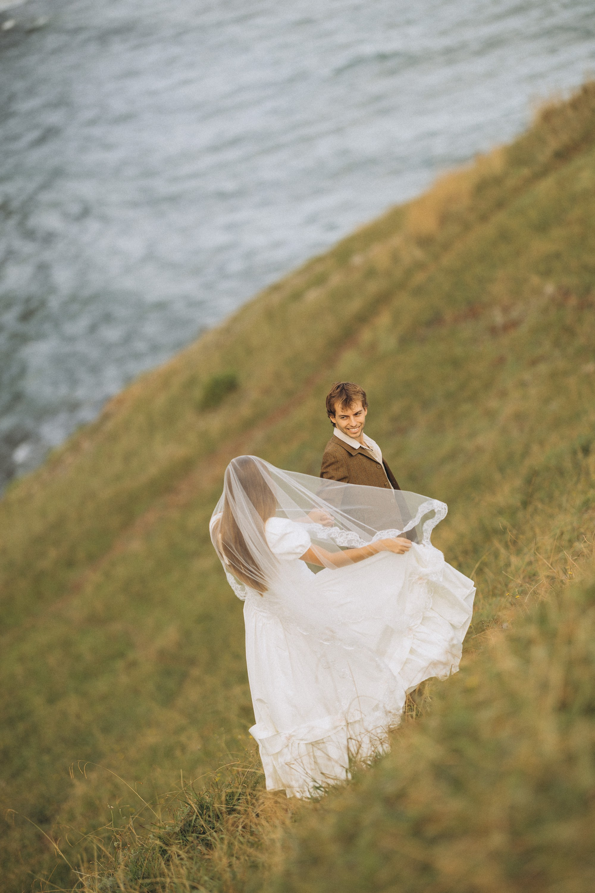 Romantic elopement in Madeira — couple exchanging vows with Atlantic Ocean views.