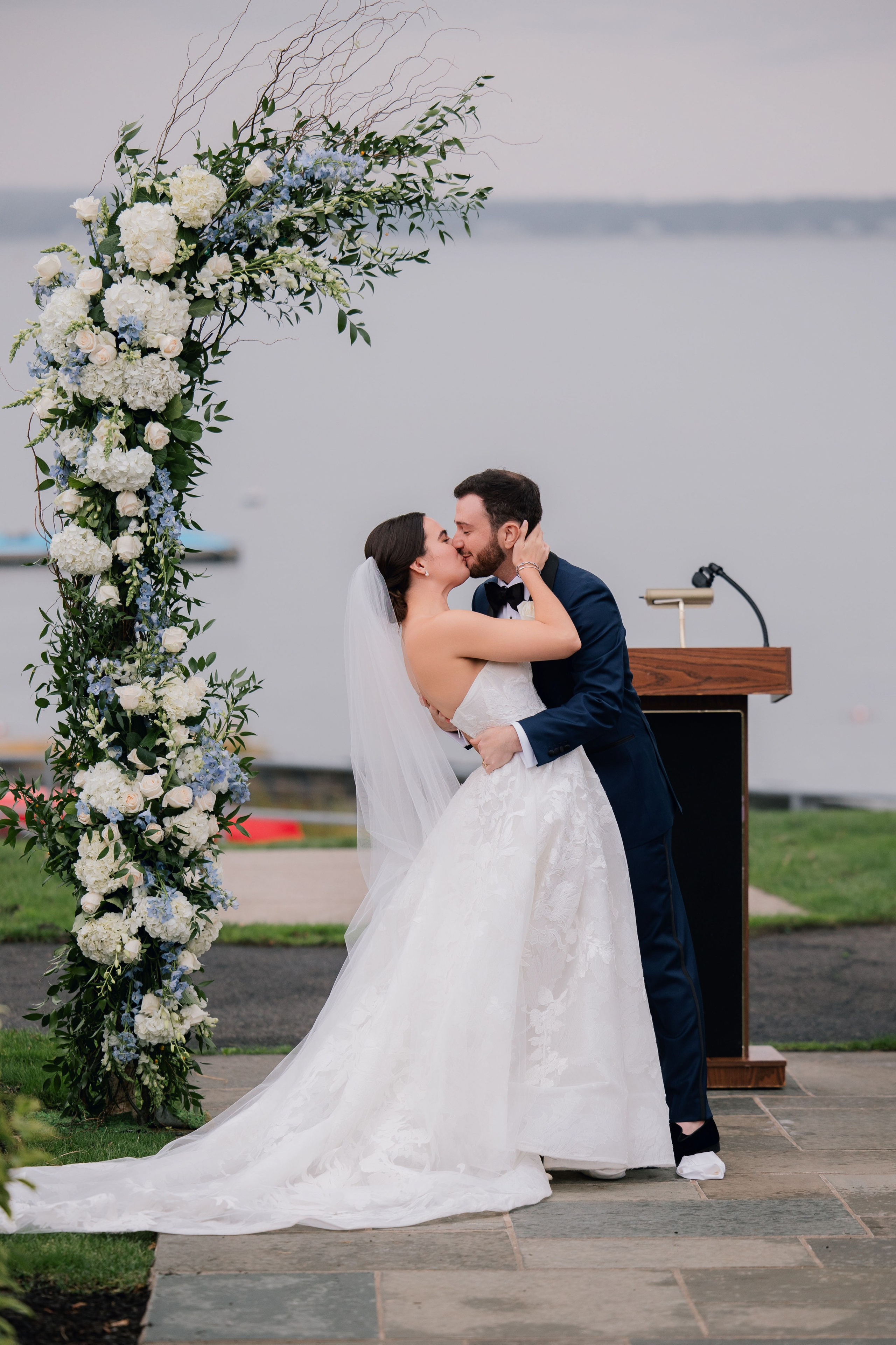 a bride and groom kiss at their wedding ceremony