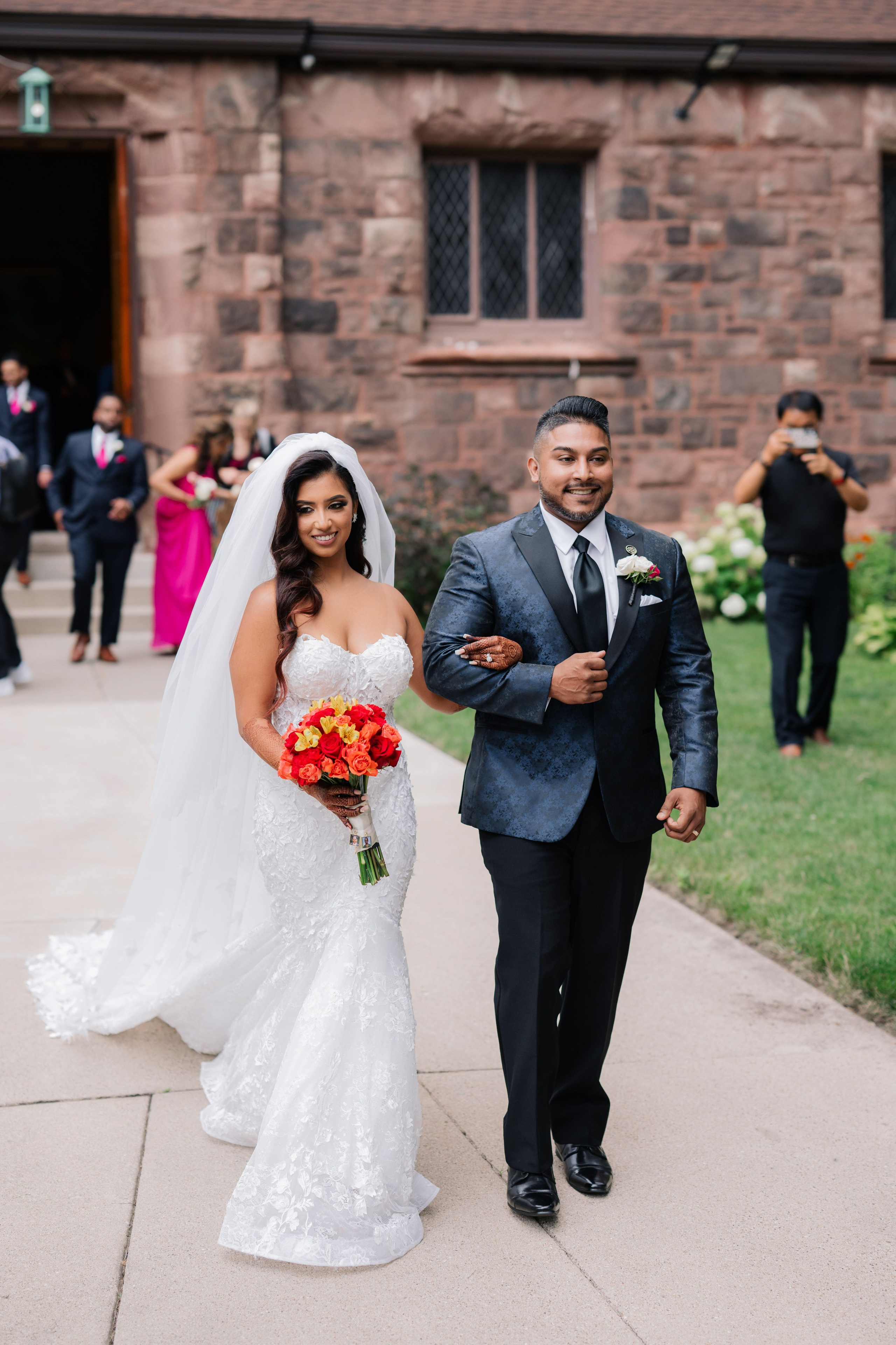 a bride and groom walking down the aisle