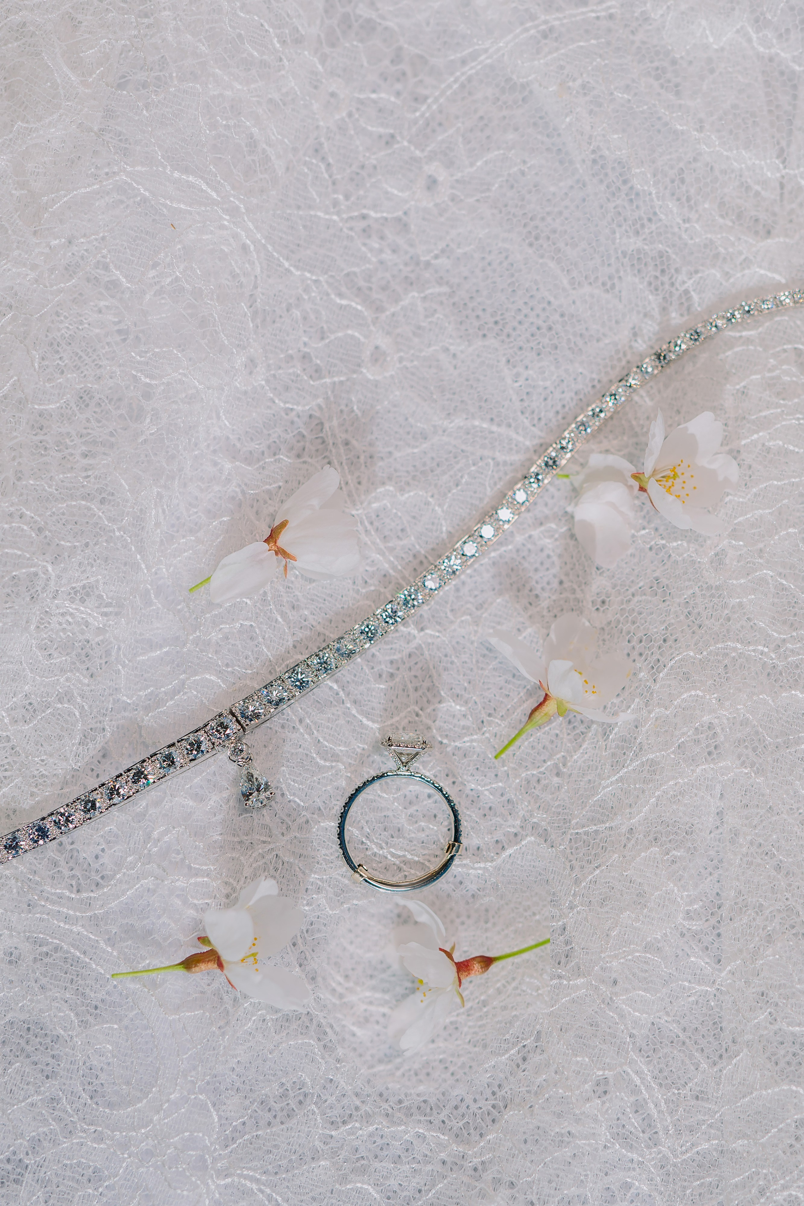 a pair of wedding rings on a white lace