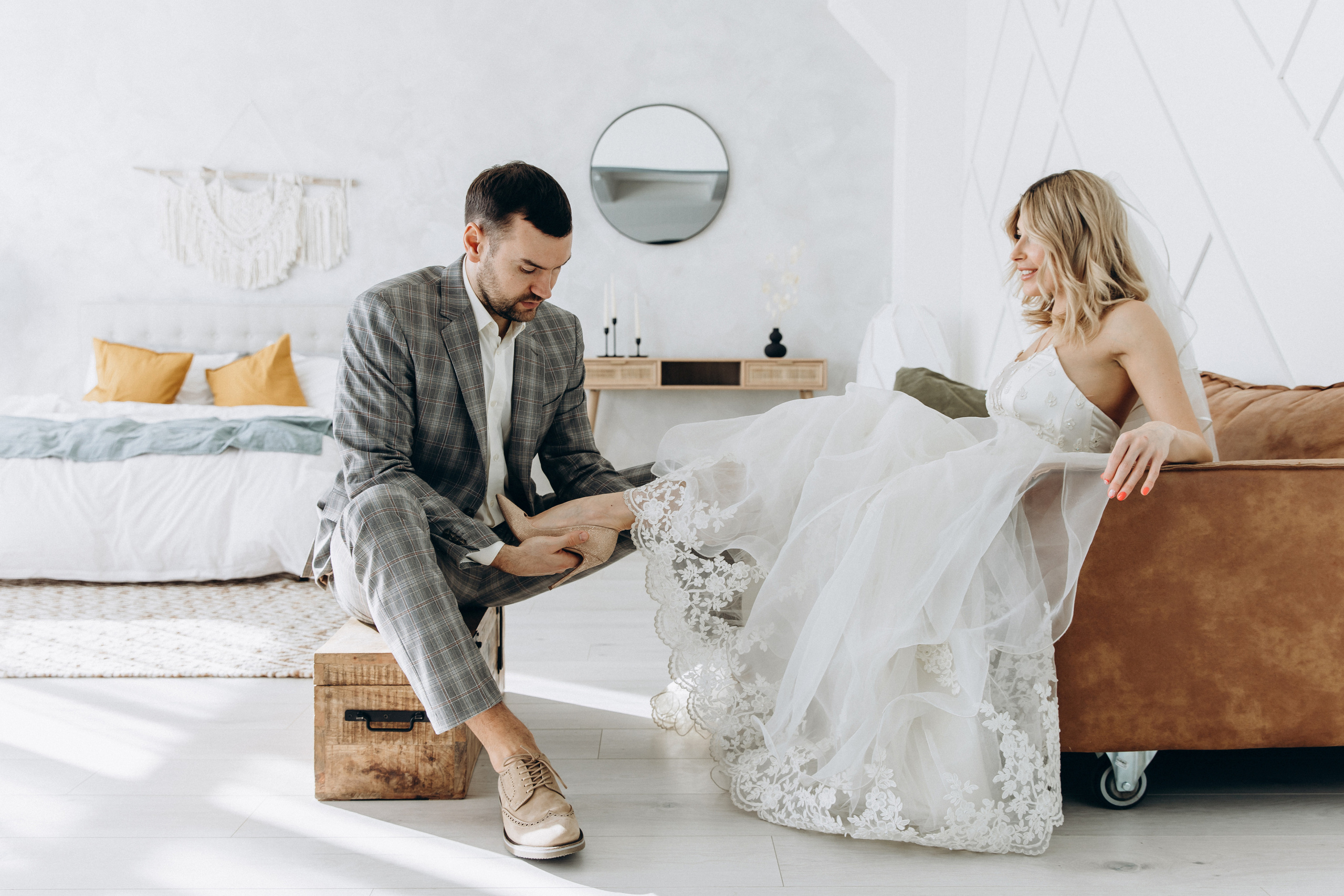 The bride and groom are on the couch, it was a wedding photo shoot in the studio