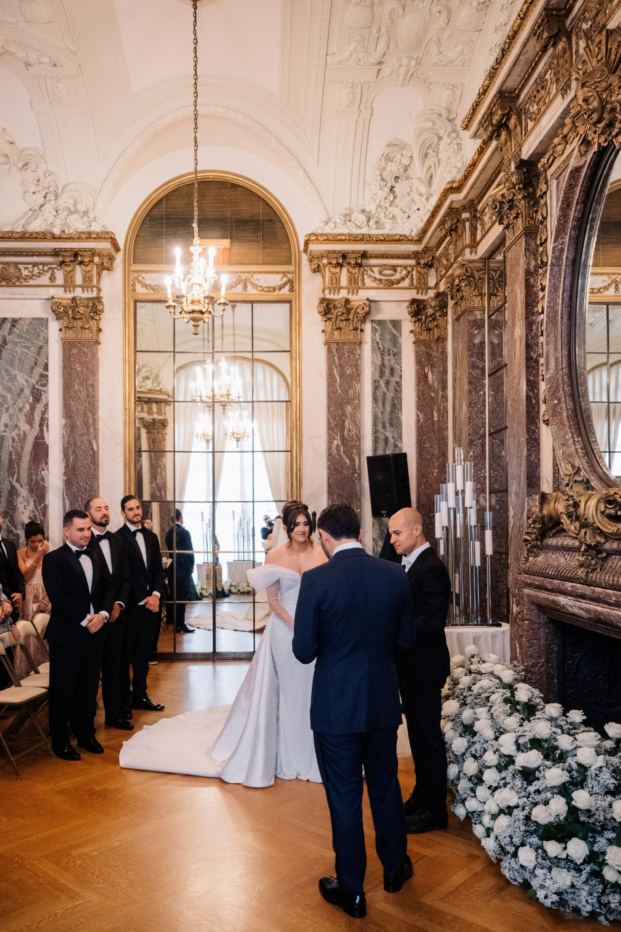 a bride and groom are standing in a room