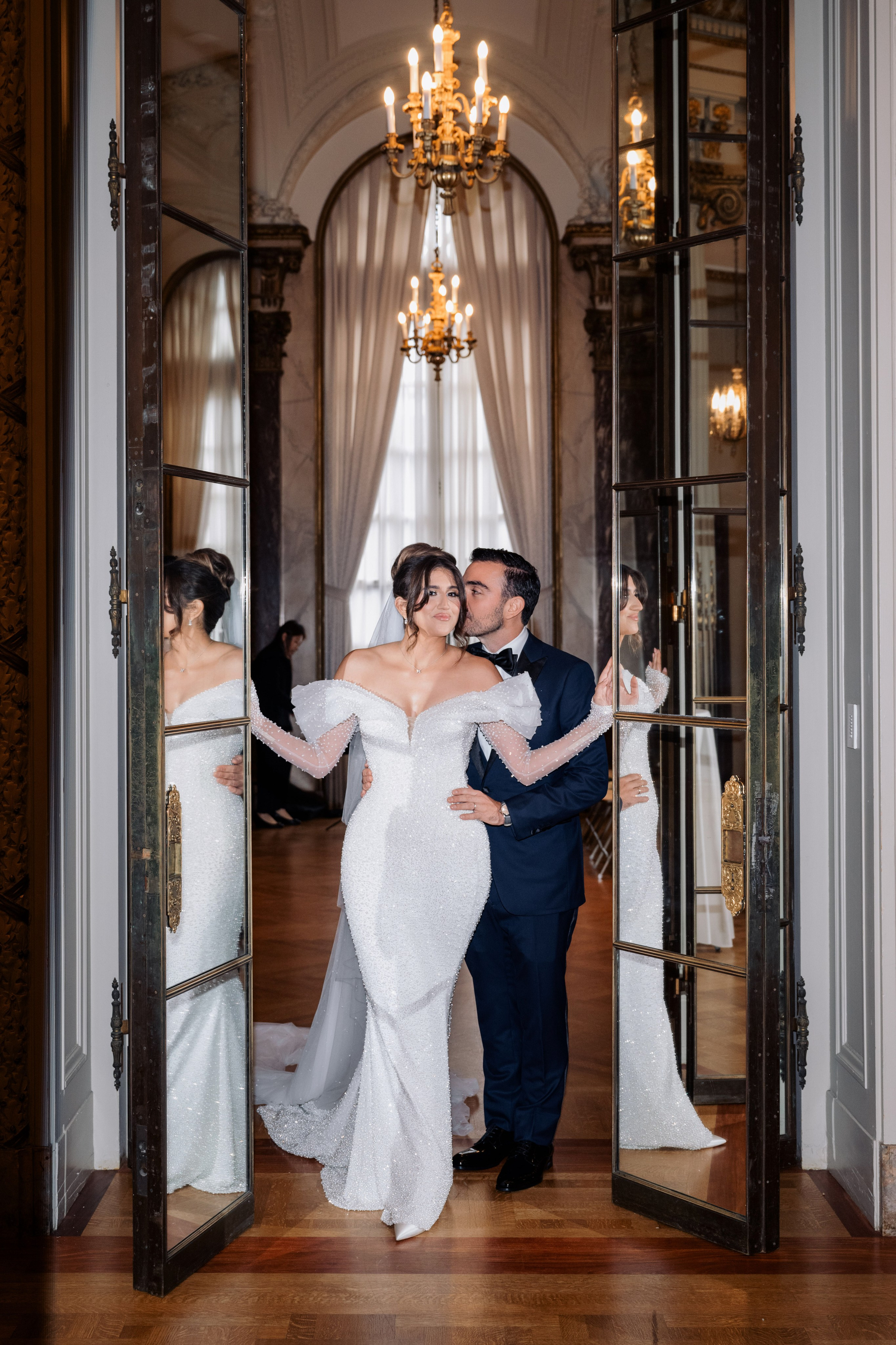 a bride and groom are standing in a doorway