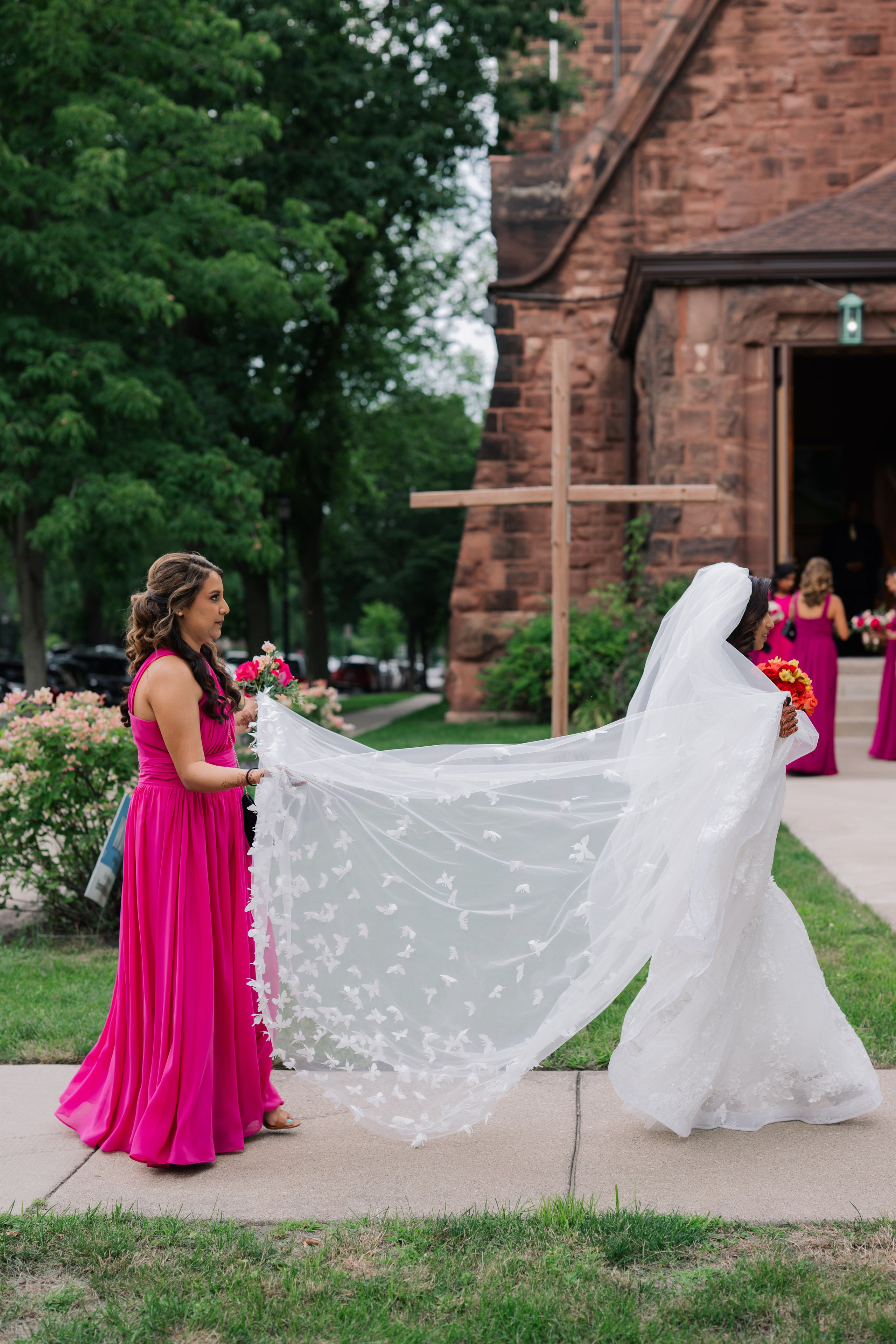 a bride and her bridesmaids walk down the aisle