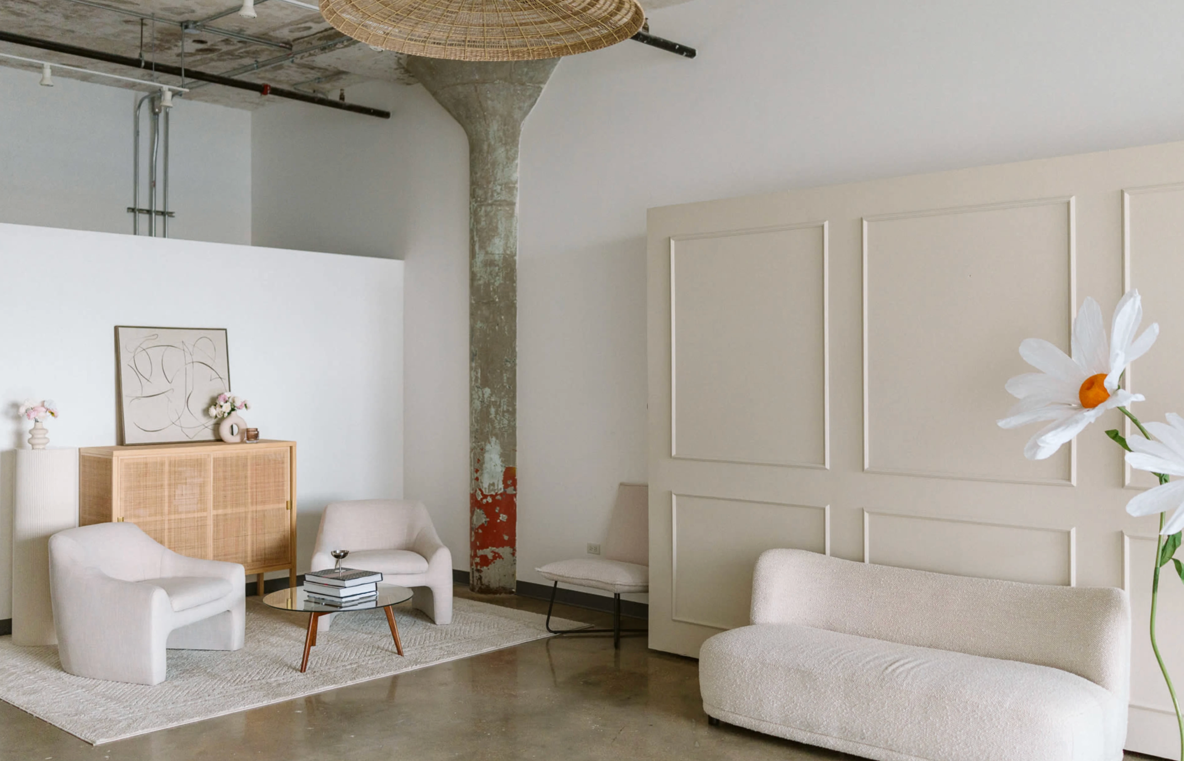 Studio space with textured backdrop, pedestal and floral styling for photoshoots