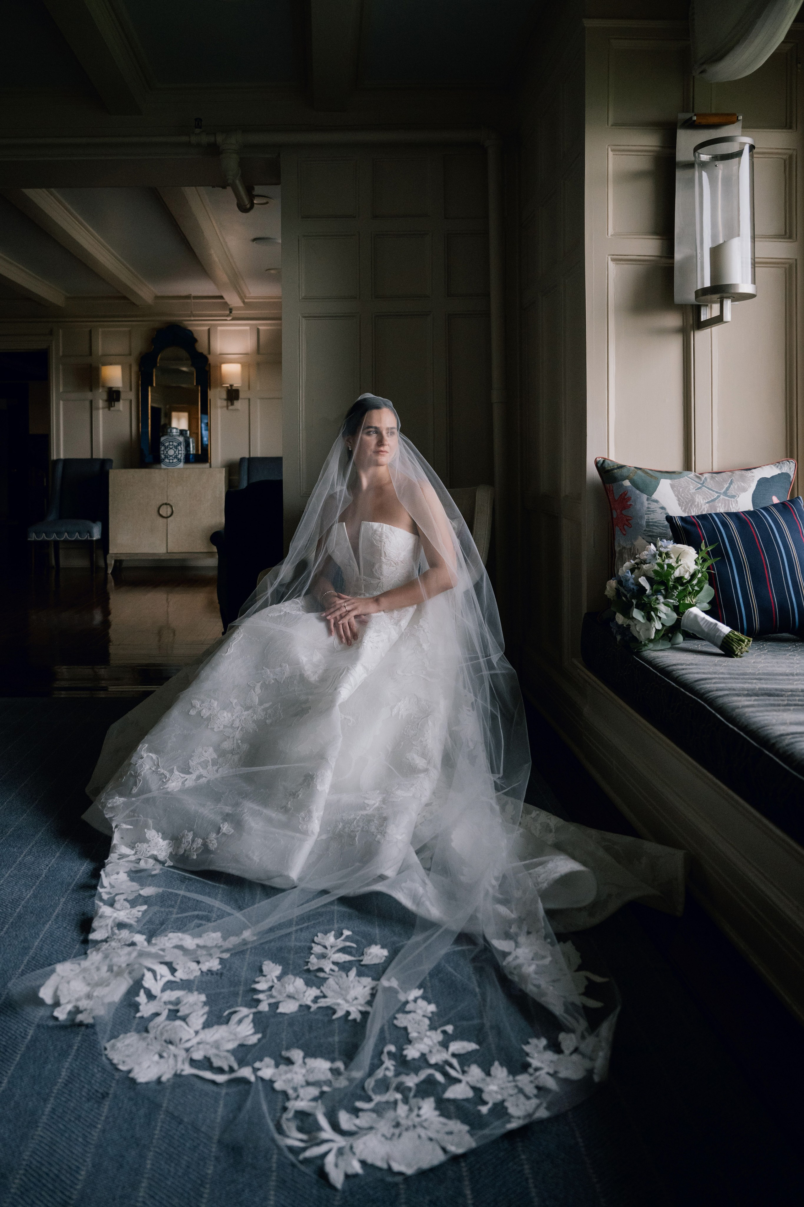 a bride sitting on a bed in a room