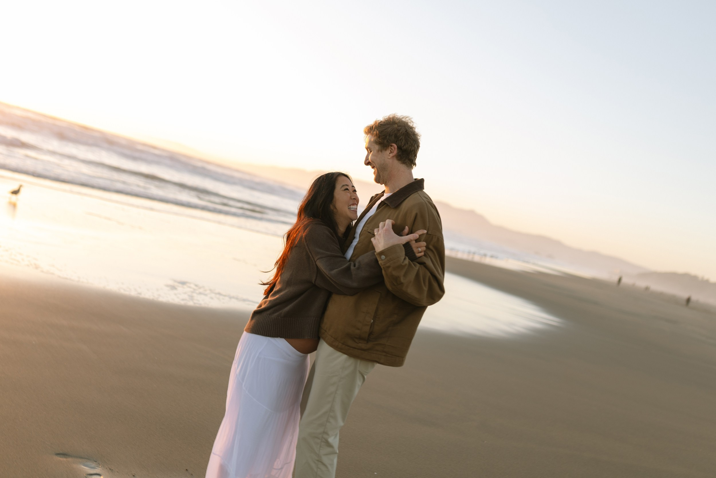 Emotional maternity session on Ocean Beach with warm evening light