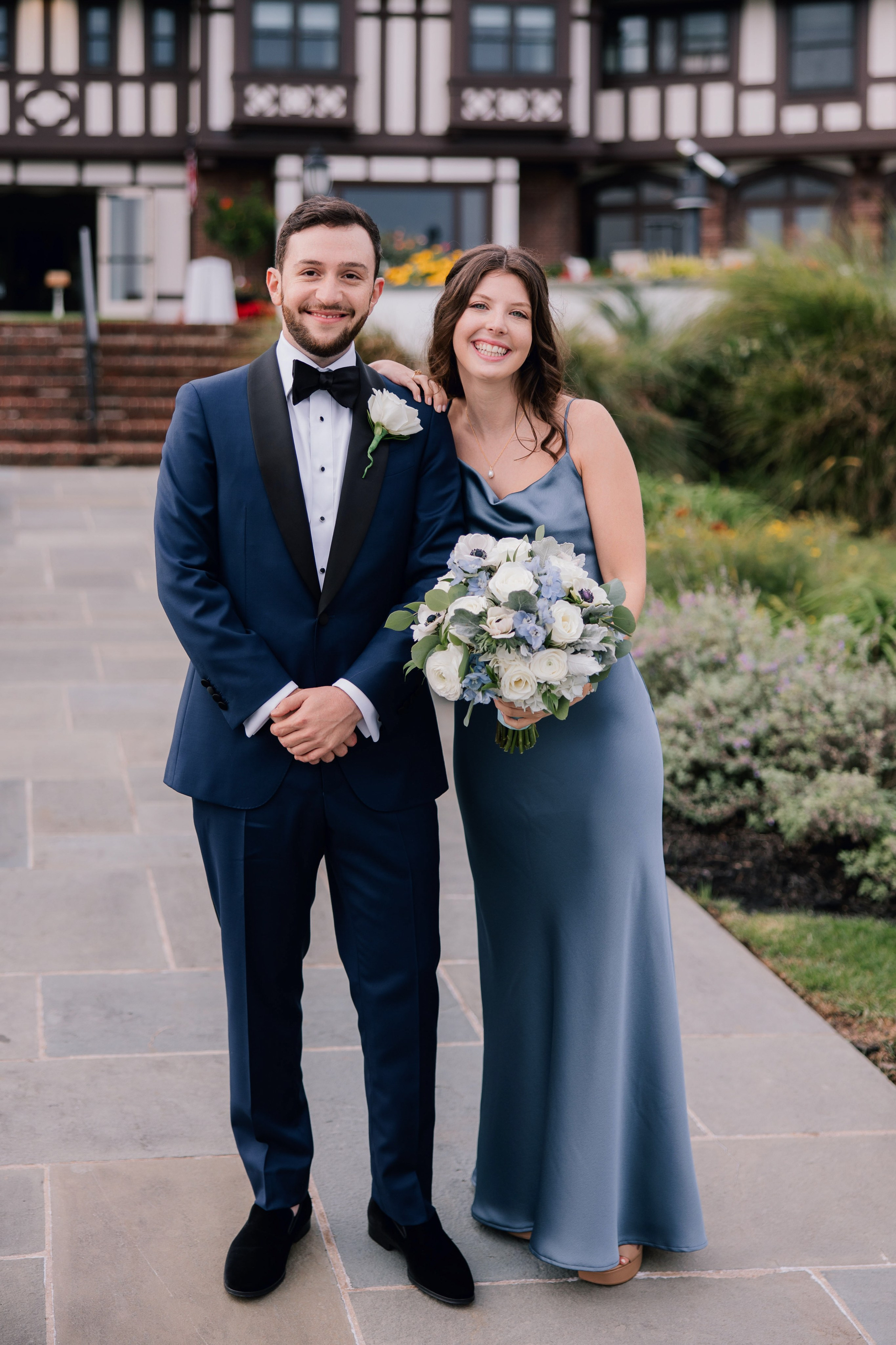 a bride and groom pose for a photo in front of the inn at the springs resort