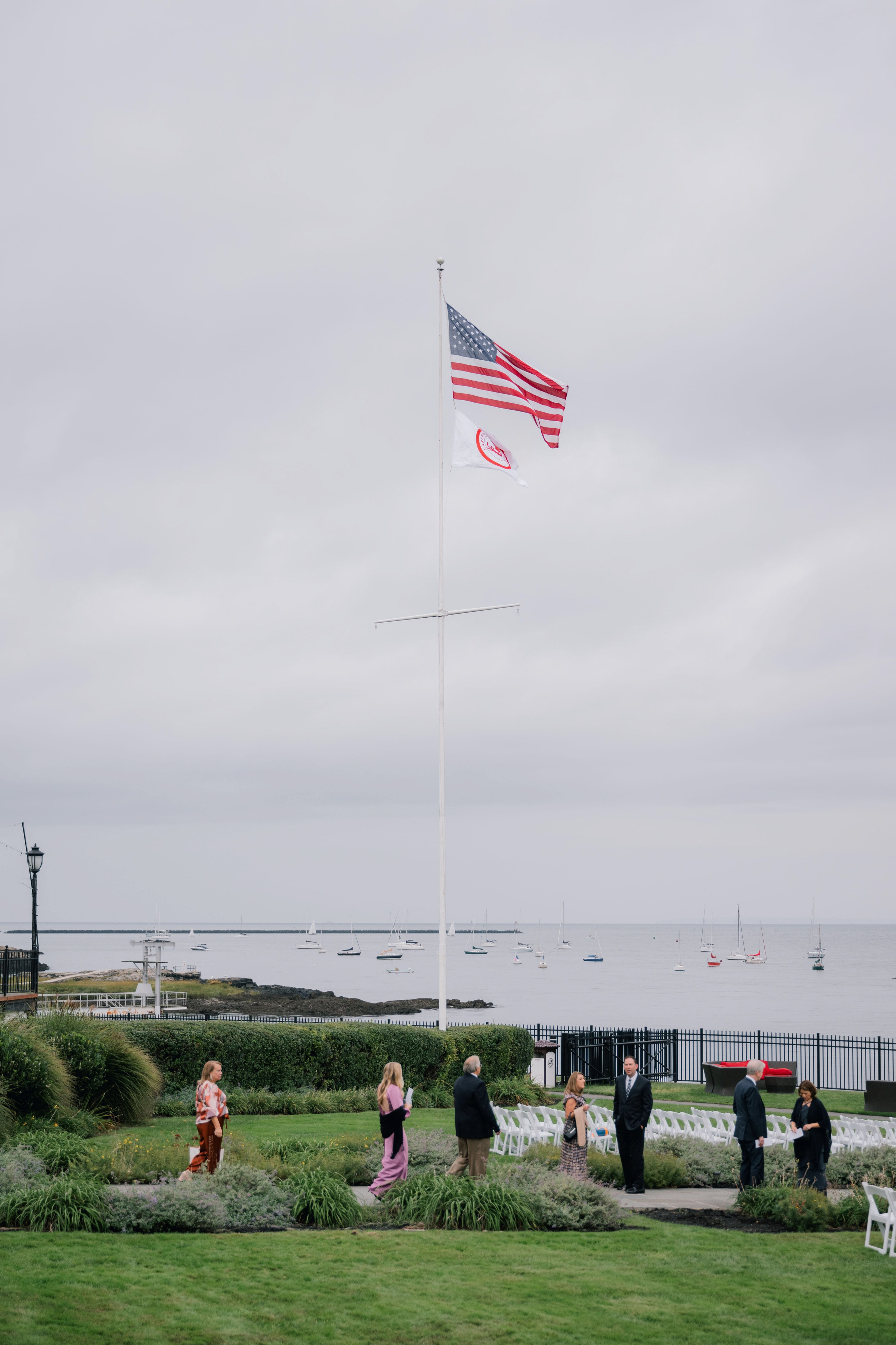 a group of people sitting on a lawn