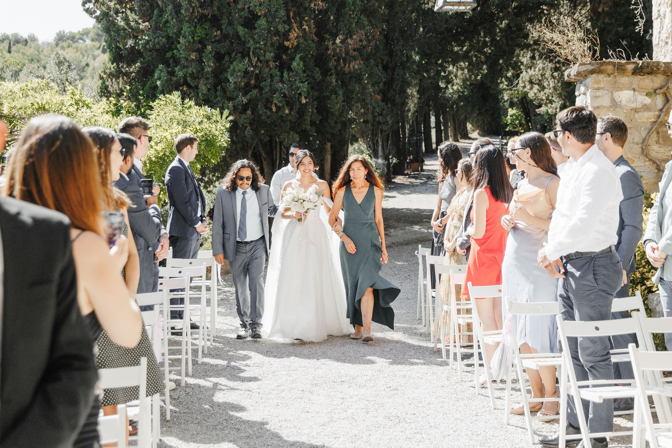 Emotional moment of the bride walking down the aisle with her parents.