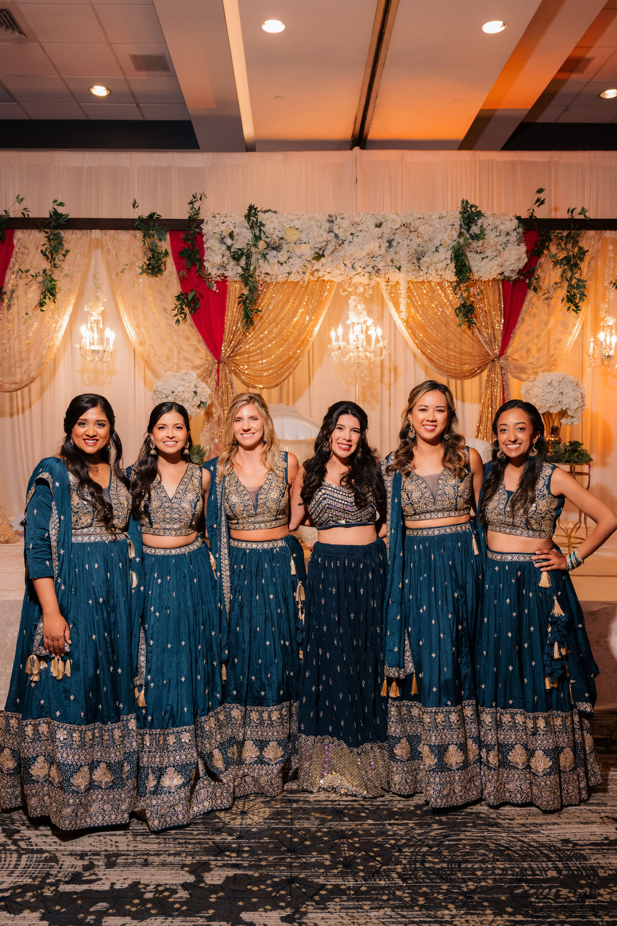 a group of women in blue dresses posing for a photo