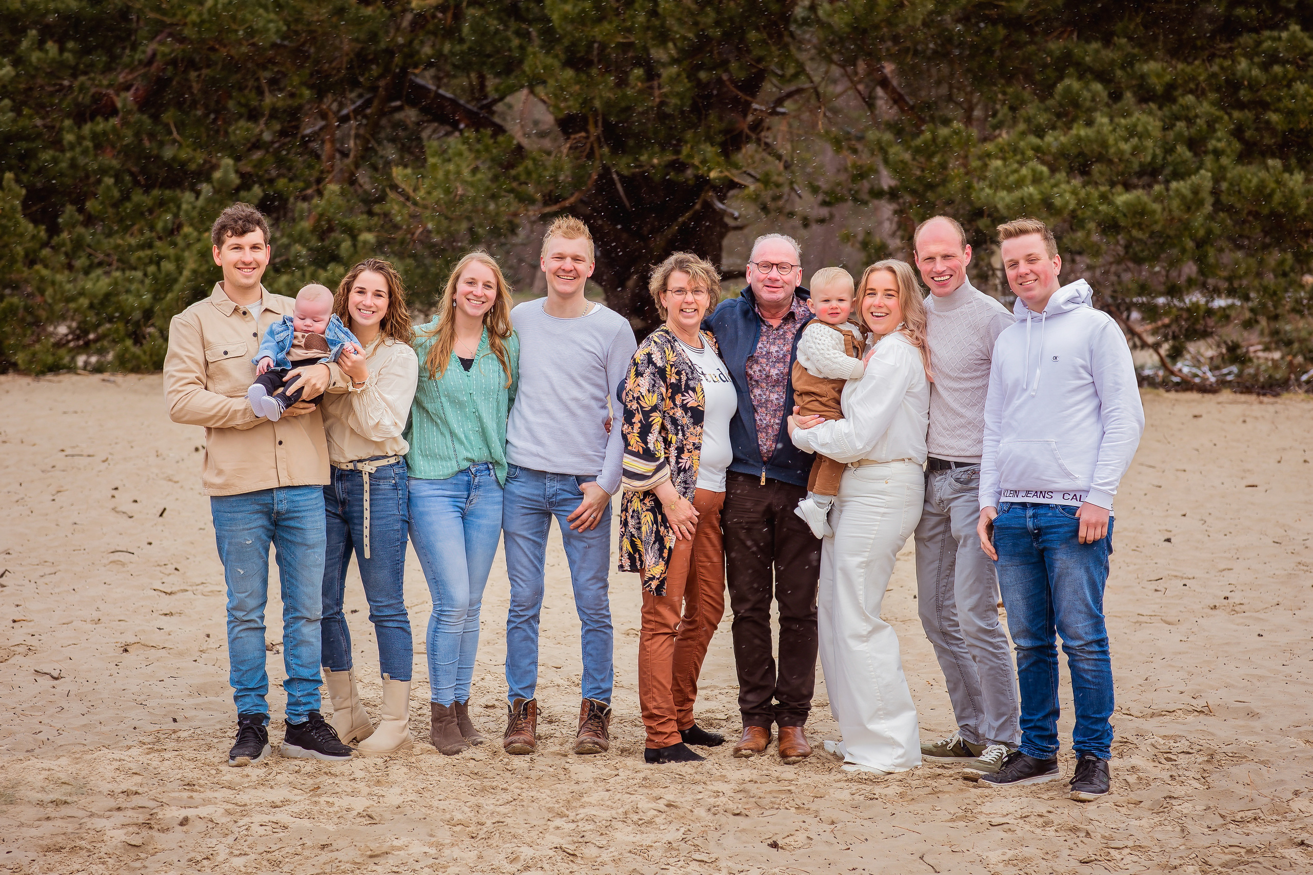 grote familie lachend op het zand
