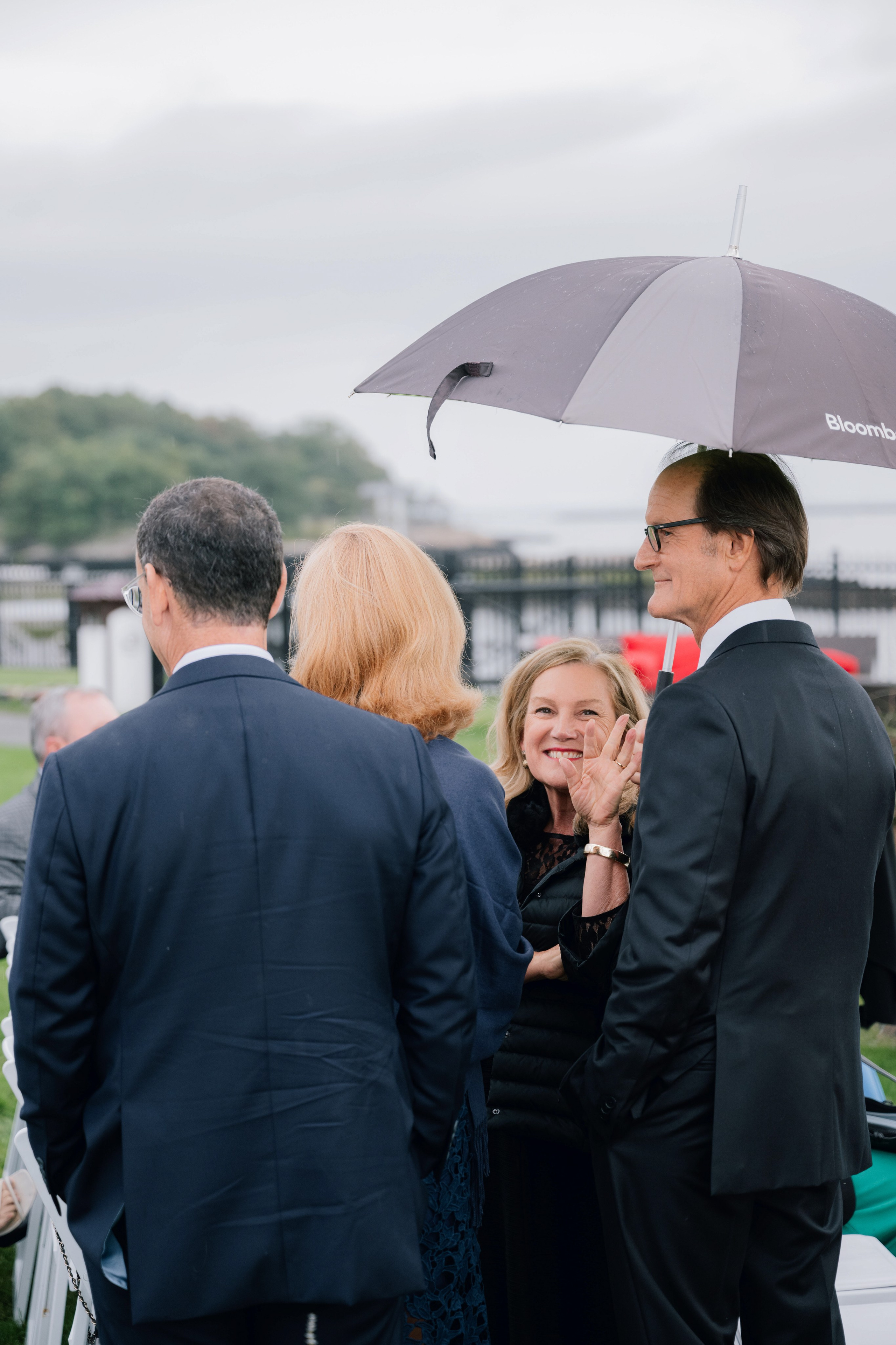 a group of people standing under an umbrella