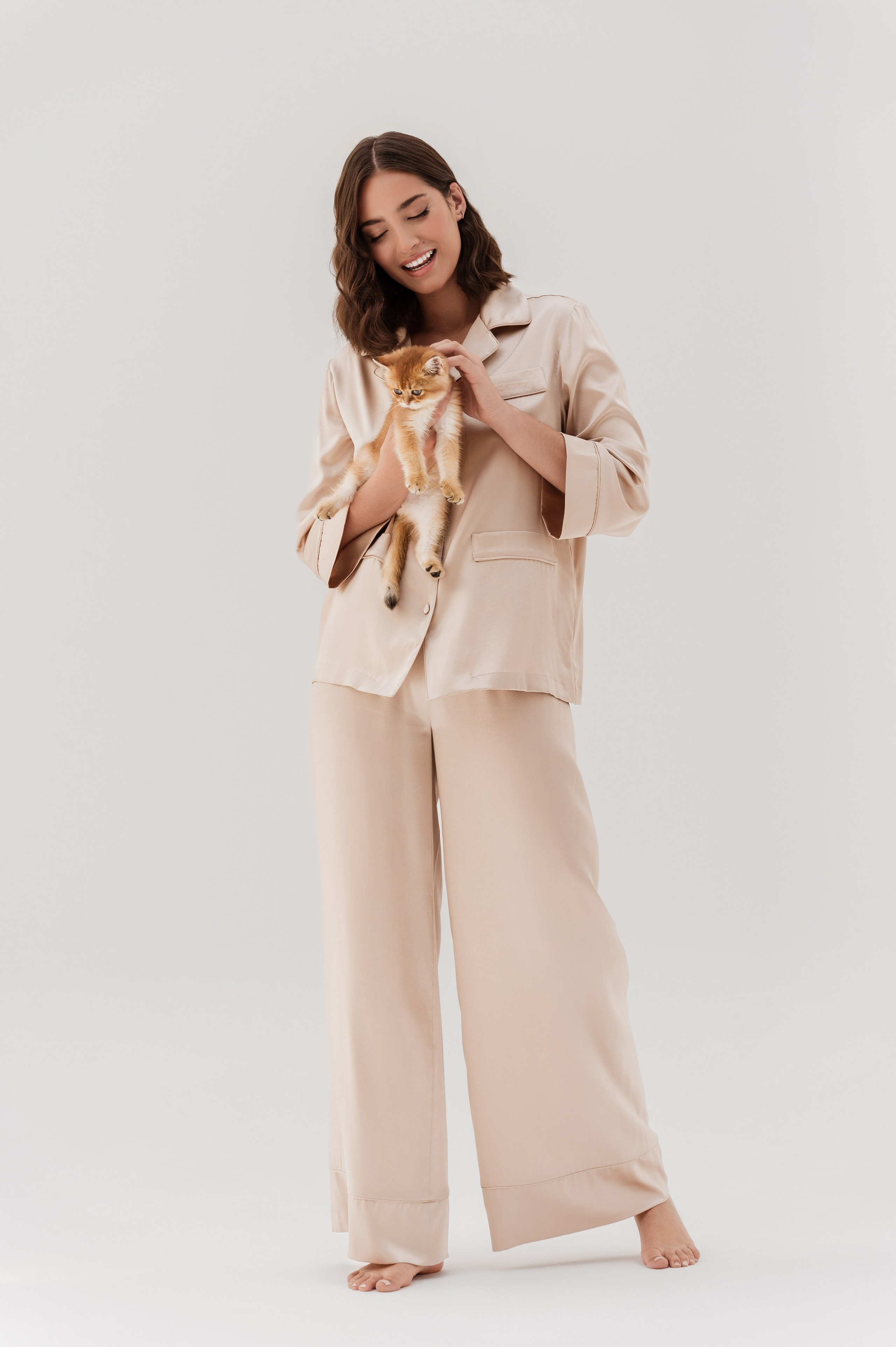 Fashion model posing in a minimalist studio setting with clean lighting, showcasing a luxury outfit in Dubai