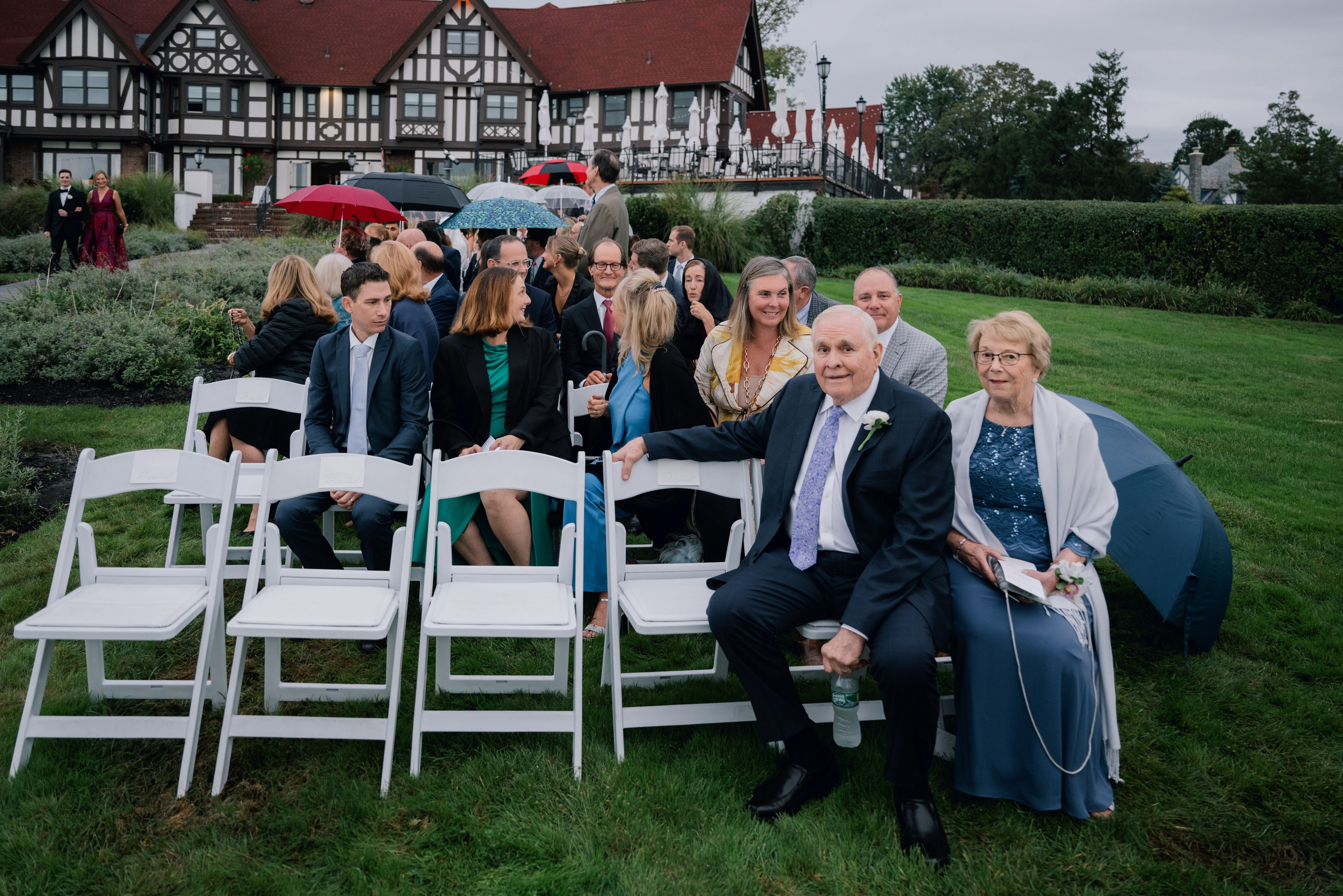 a group of people sitting on a lawn