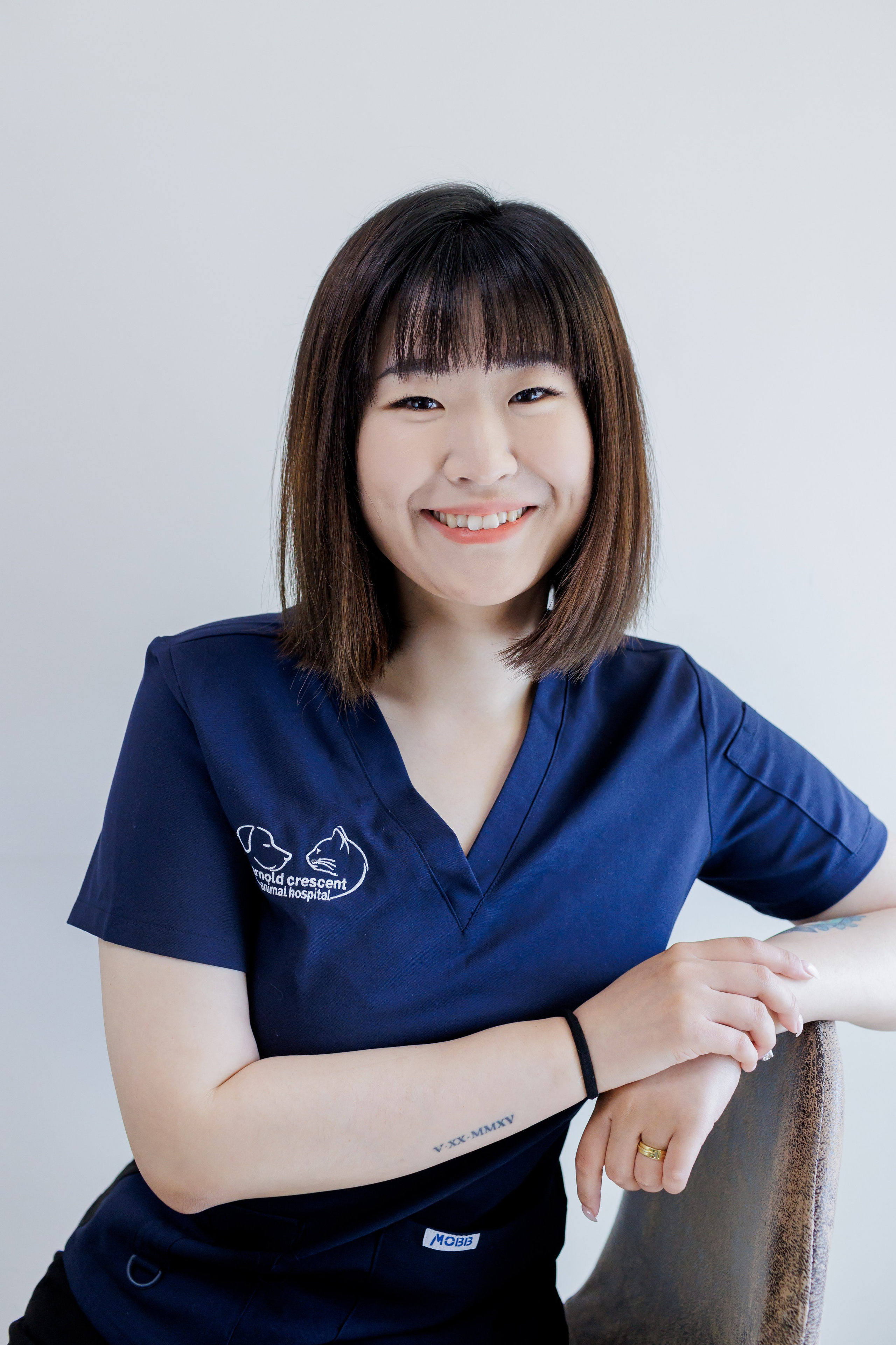 HEADSHOT OF ASIAN WOMAN IN SCRUBS