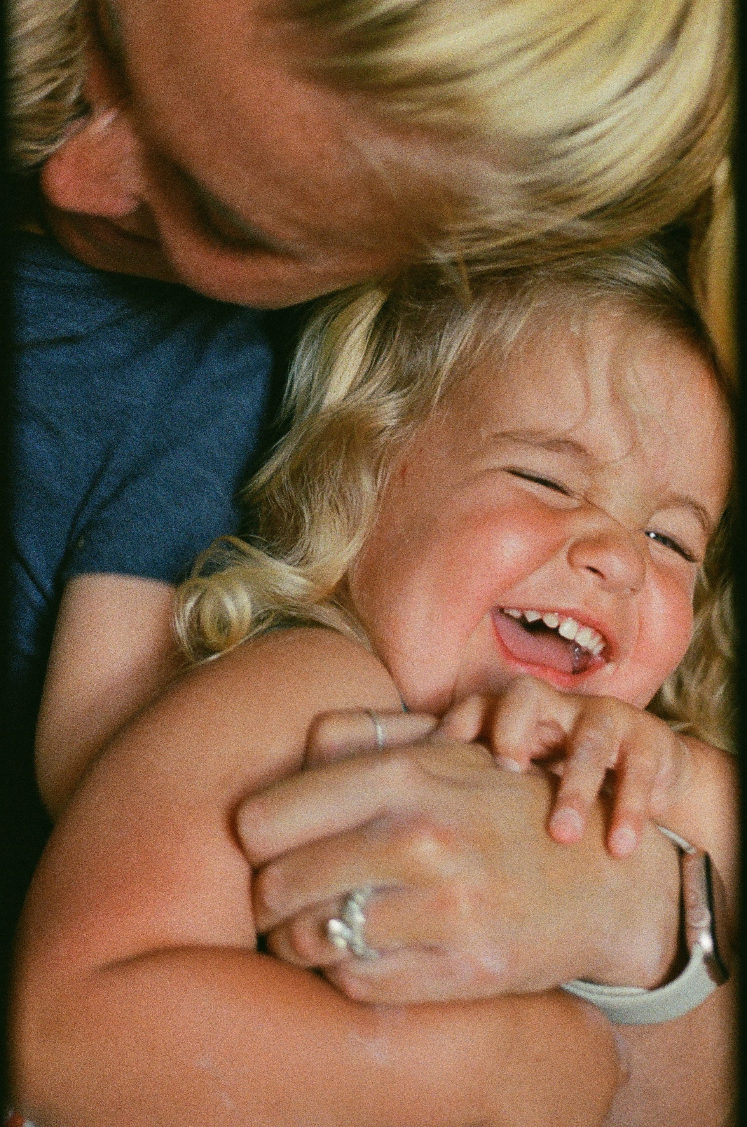 Mom and her daughter are laughing during a family session in Richmond, VA