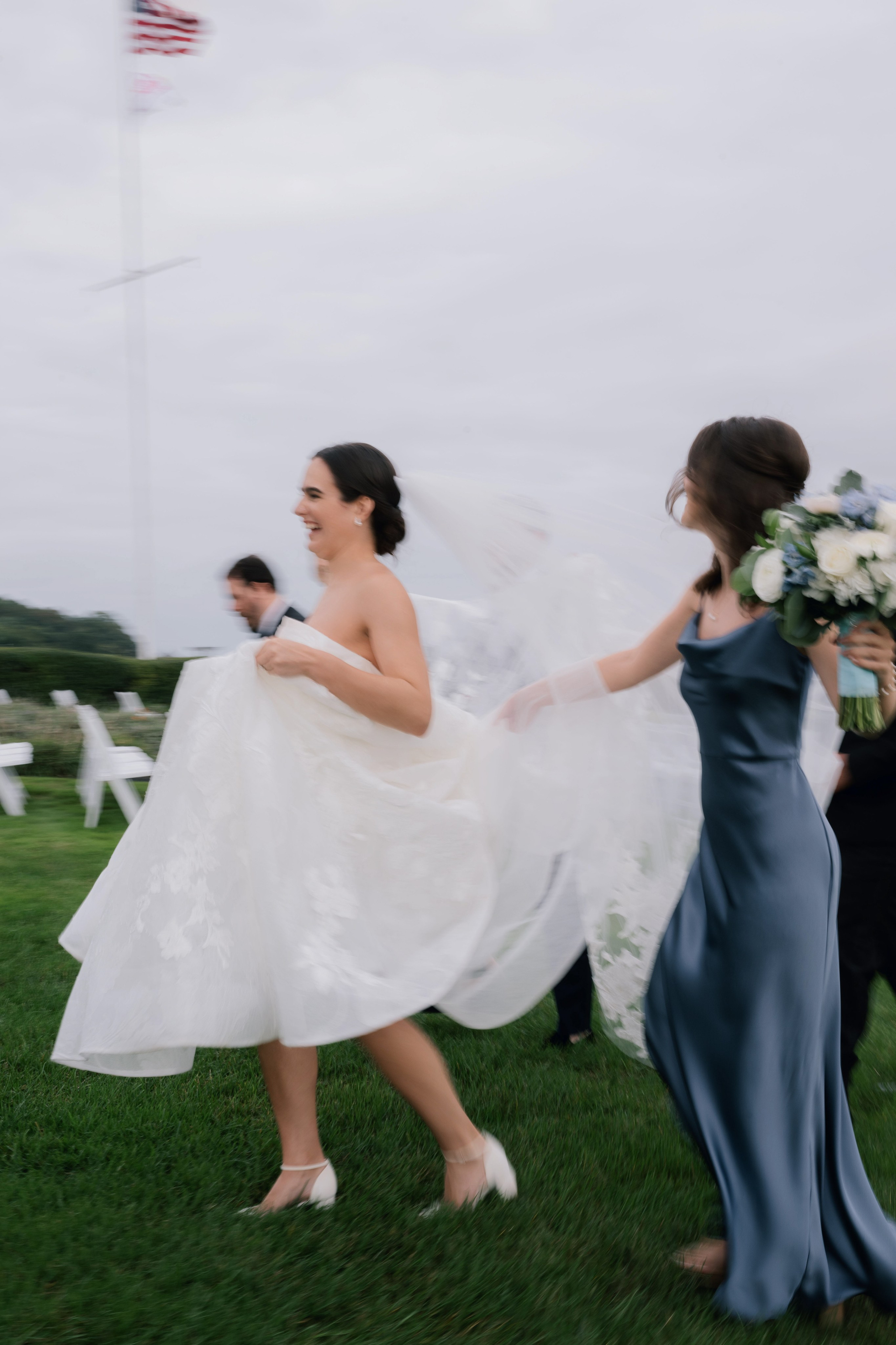 a bride and her bridesmaids walk through the cemetery