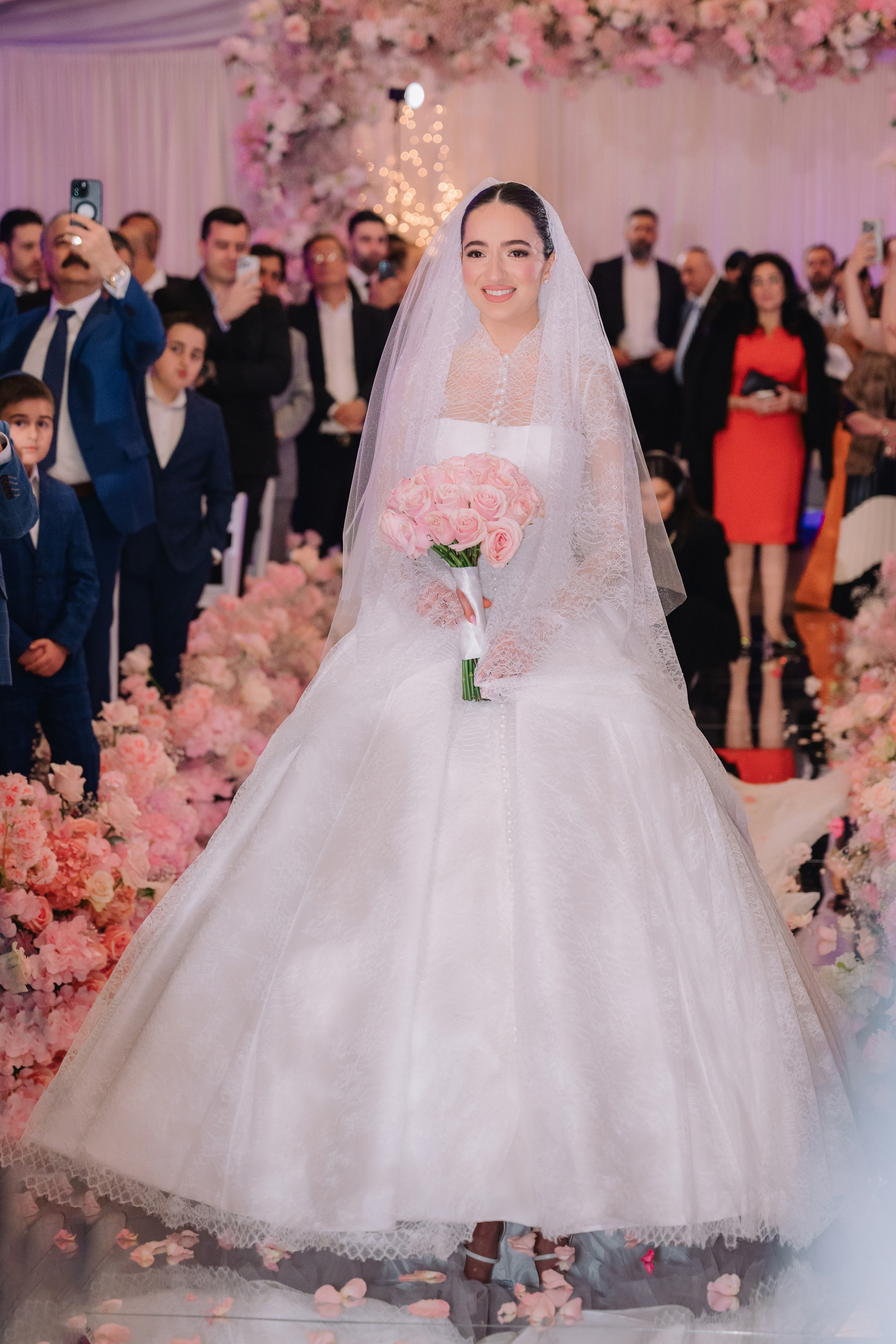 a bride walking down the aisle with her bouquet