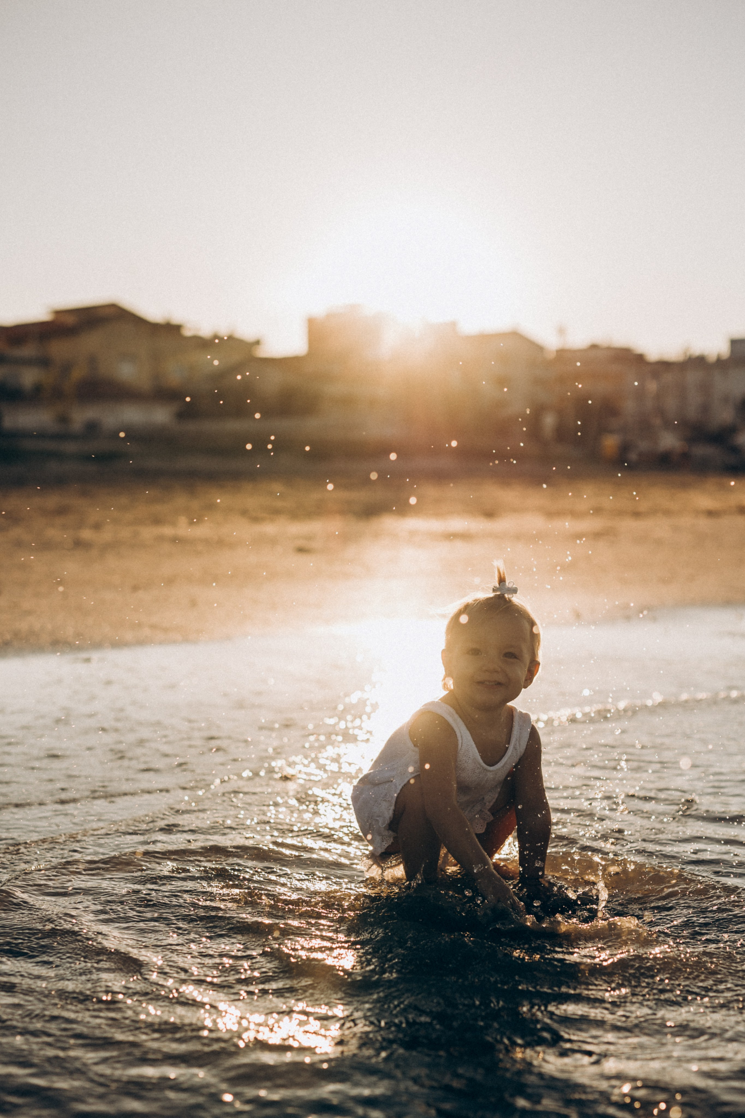 Bambino che gioca in acqua al tramonto durante un servizio fotografico a Rimini