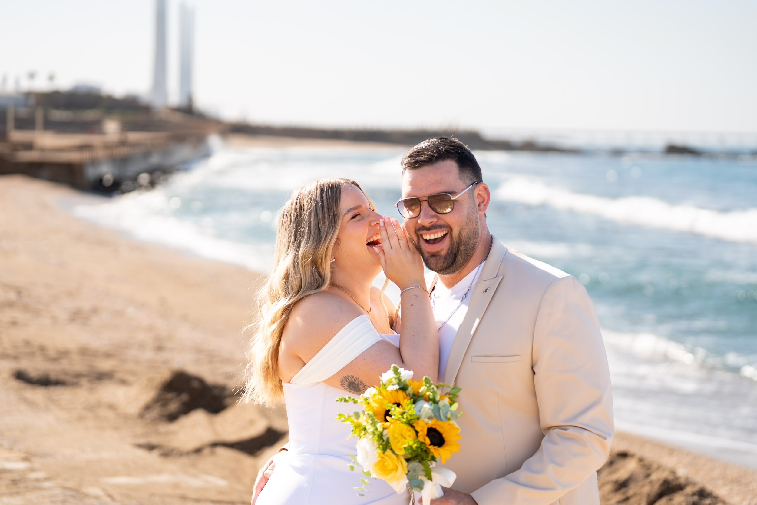Yael whispers to Natanel during a quiet moment by the sea